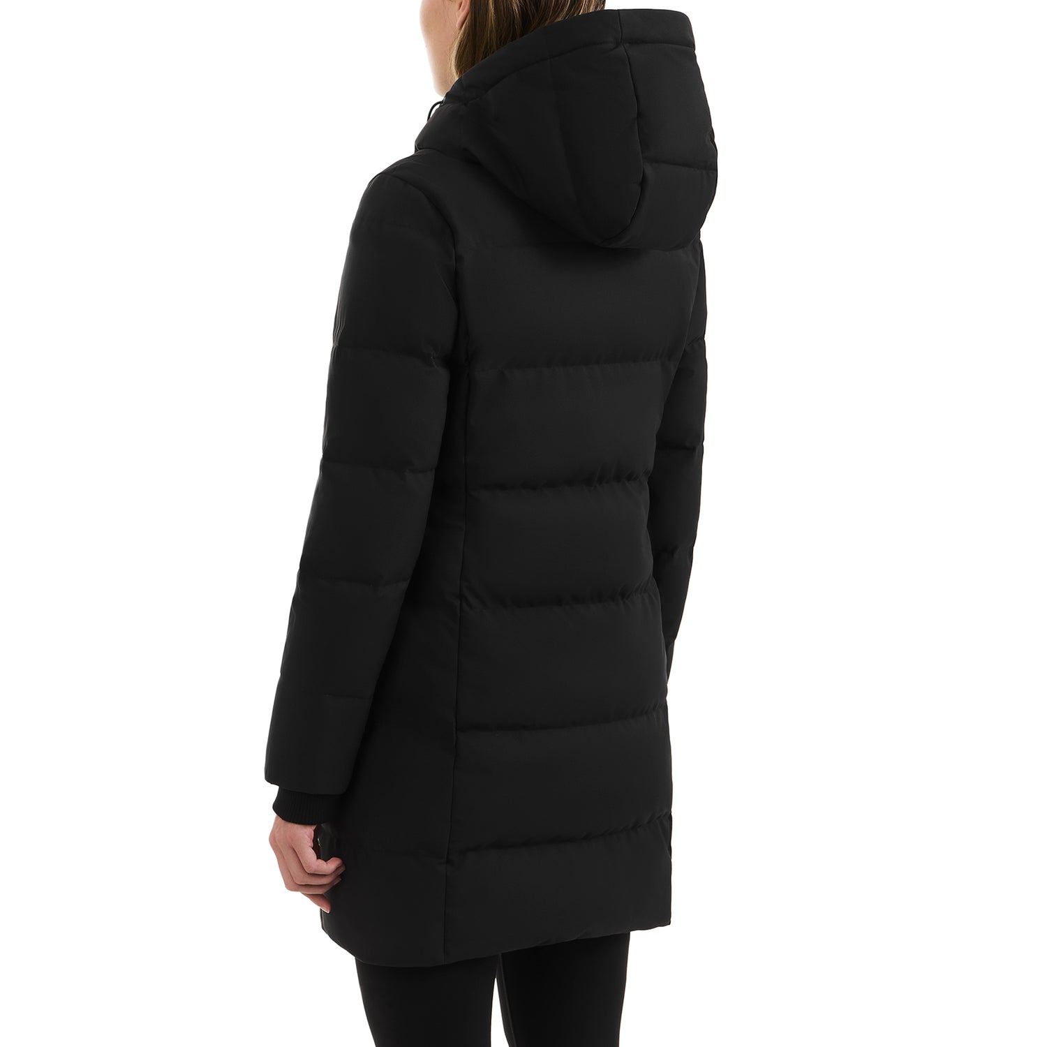 A person with long brown hair stands facing away, showcasing the back and left side of the Rudsak SYDNEY COM - 4123511 Black hooded duck-down parka, paired with black pants.