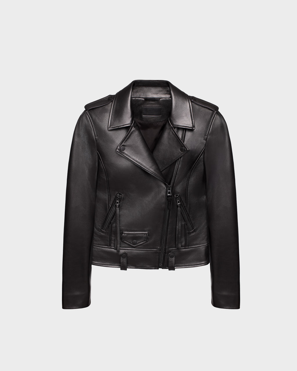 The MERGO - 8122009 BLACK by Rudsak is a women’s black lambskin leather biker jacket with a notched lapel collar, asymmetrical front zipper, and zippered pockets, shown on a plain light gray background.
