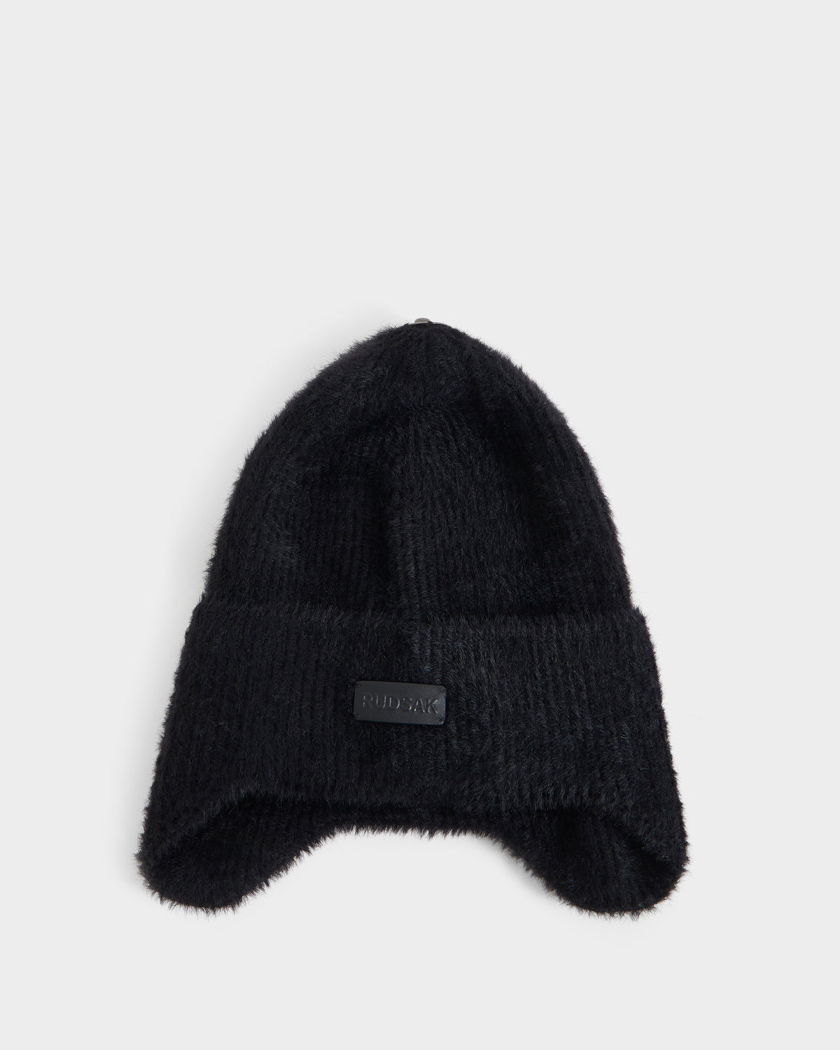 A black knit beanie from Rudsak, the ICE - 8426519 Black, featuring a folded brim and a small rectangular patch on the front, displayed against a plain white background.
