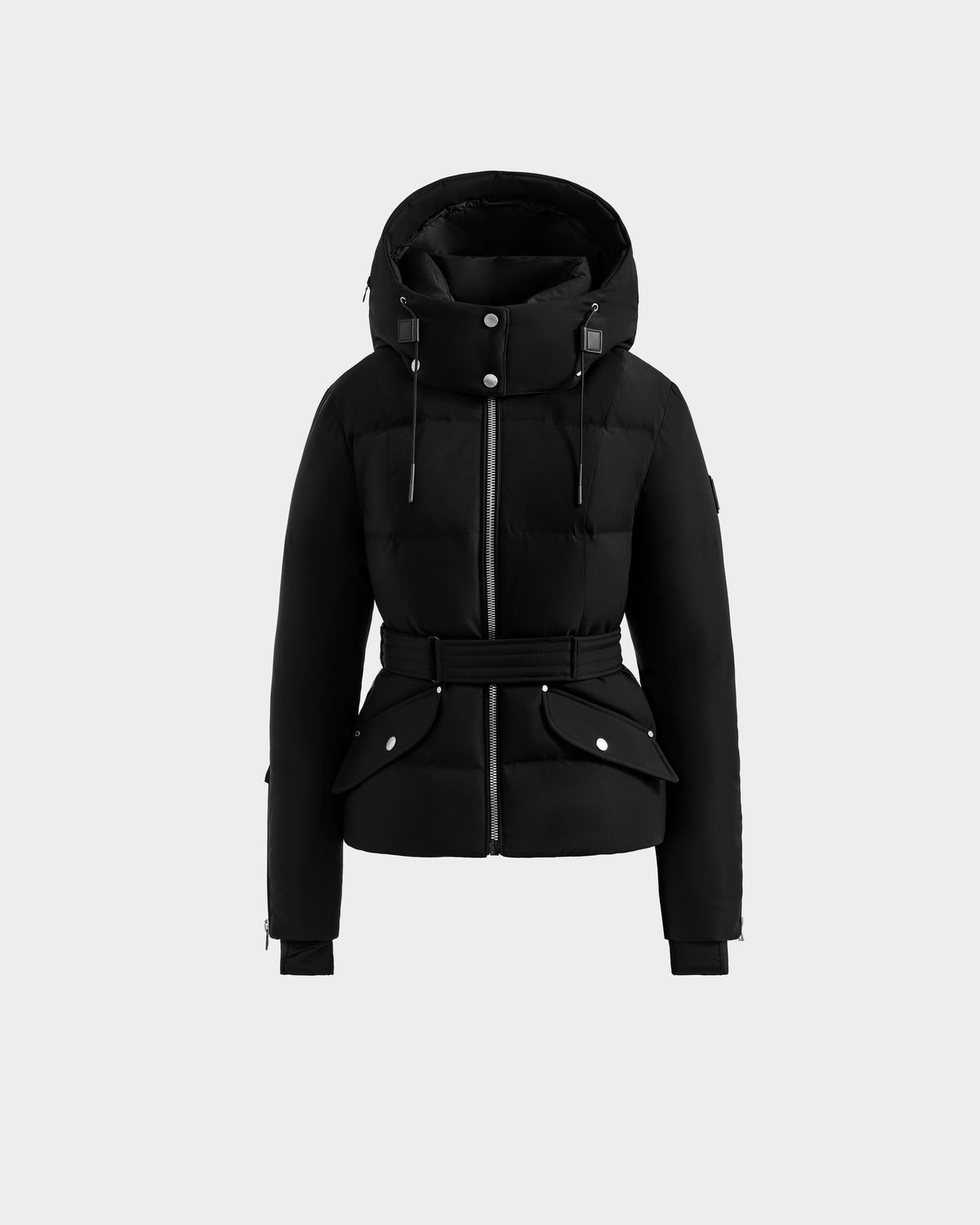The Rudsak ADELINE H - 8125587 Black is a chic women’s down puffer winter coat featuring a hood with drawstrings, front zipper, belted waist, snap buttons, and two front pockets, displayed against a plain light gray background.