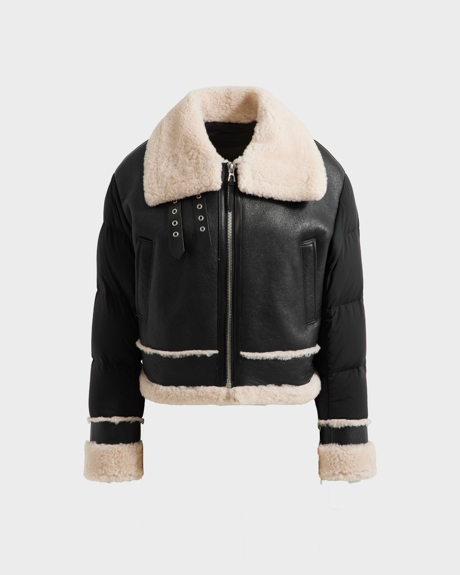 The Rudsak ANA - 8125508 Black is a womens black leather shearling jacket with beige lining, a wide shearling collar, zip front, side pockets, and plush trim on cuffs, hem, and seams—shown on a plain white background.