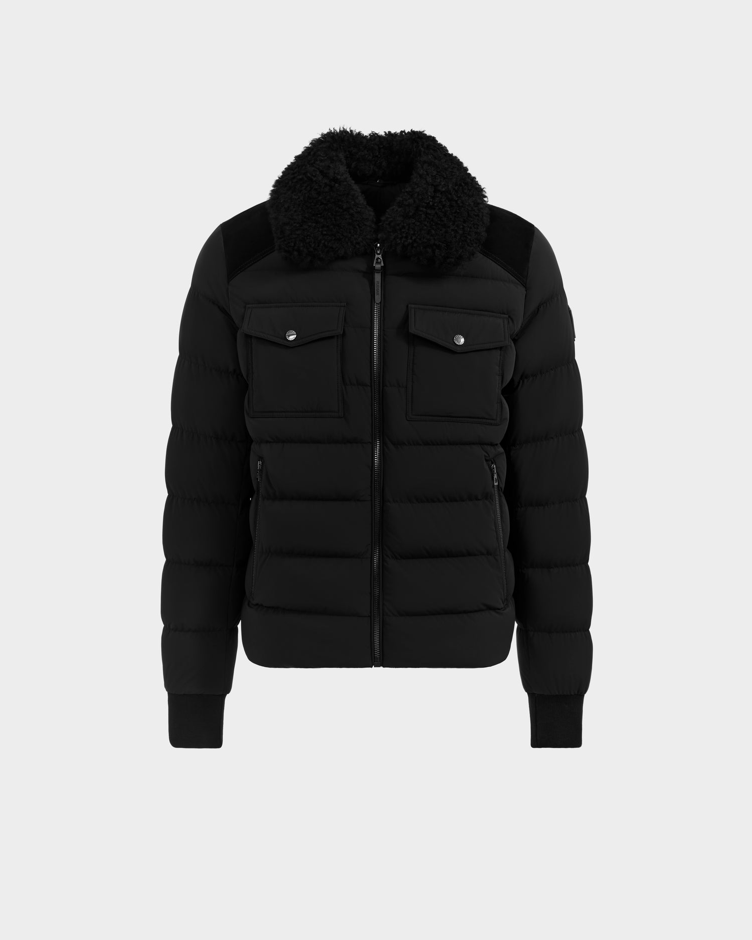 The Rudsak ANTHONY - 6125042 Black men’s aviator jacket features a front zipper, two buttoned chest pockets, and a shearling collar, shown on a plain light background.