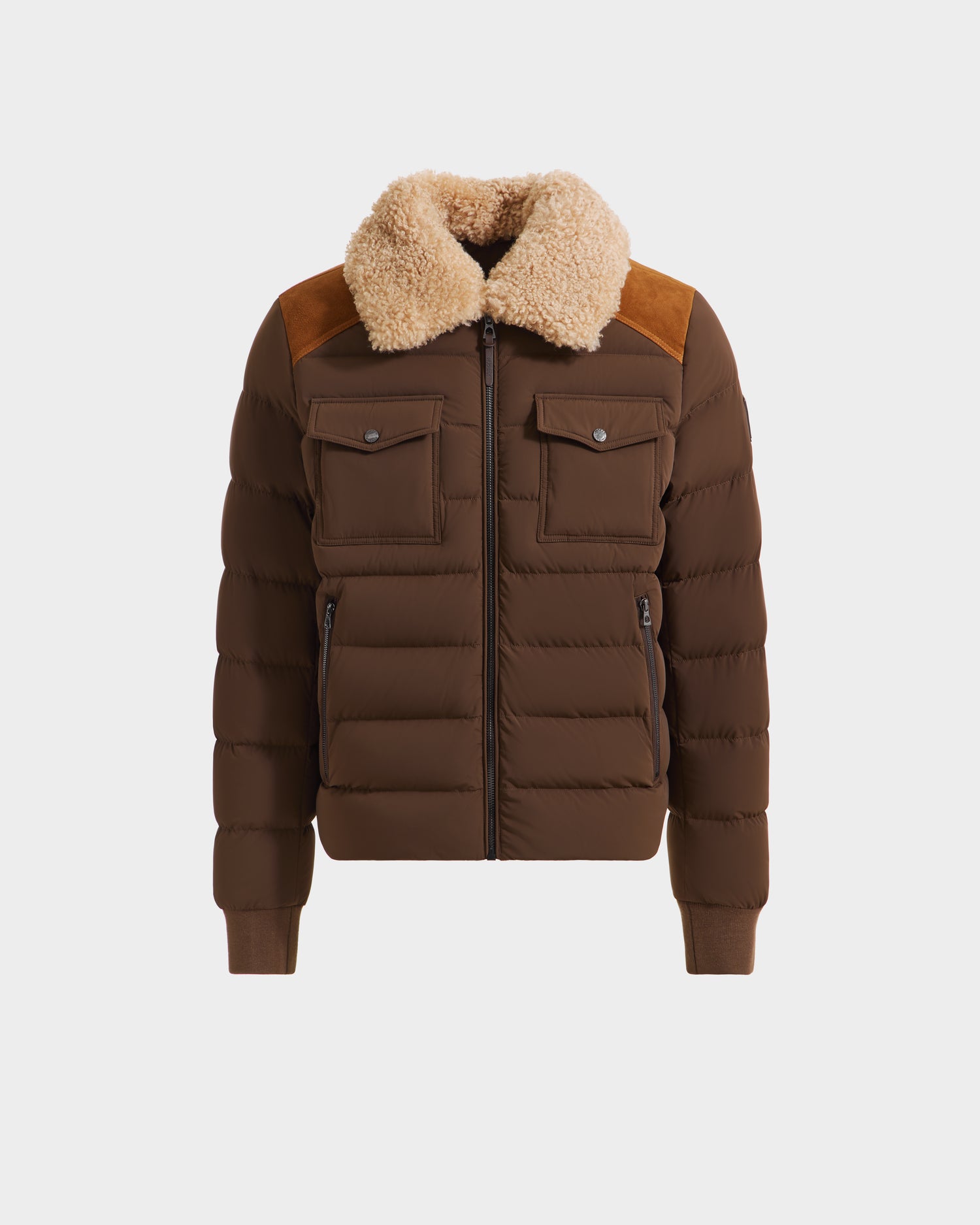 The Rudsak ANTHONY - 6125042 Mocha is a brown men’s aviator jacket with a beige shearling collar, front zipper, chest and side pockets, ribbed cuffs and hem, and suede shoulder panels for added style.