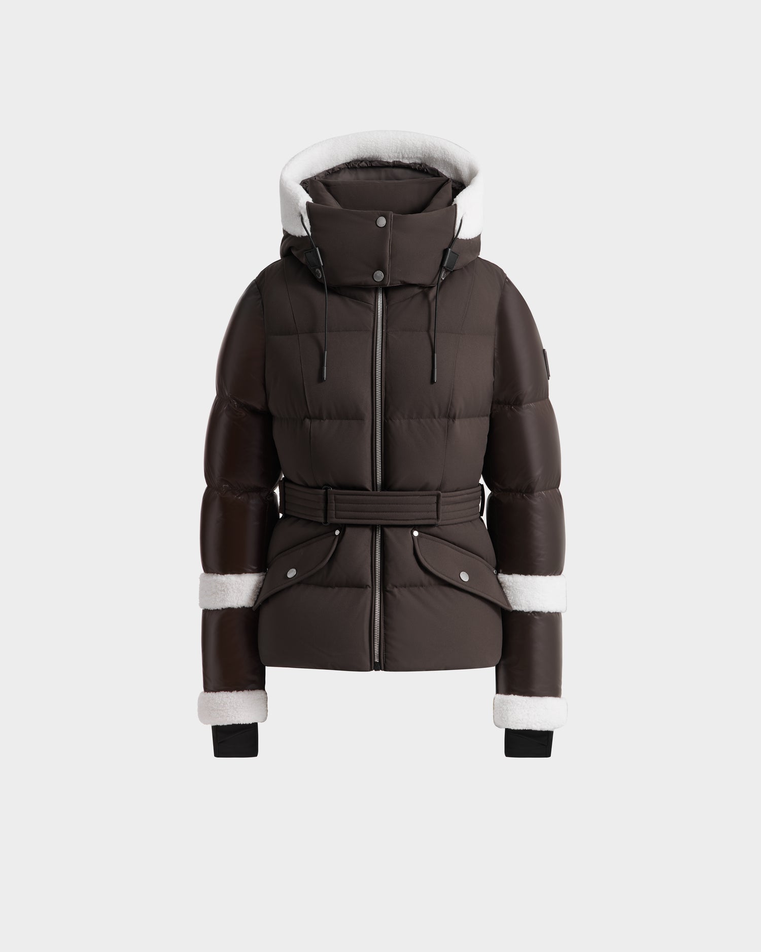 The Rudsak AUDREY - 8124582 Espresso is a dark brown down puffer jacket with a belted waist, white faux fur trim, front zipper closure, two snap pockets, and black ribbed wrist cuffs—crafted from recycled Stormshell fabric.