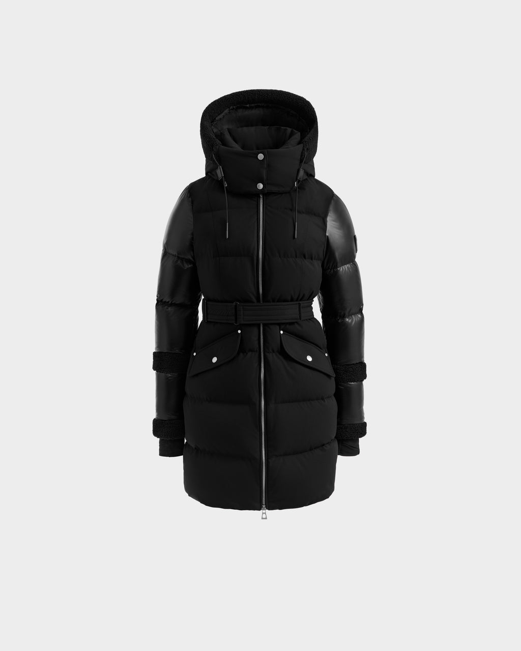The Rudsak AUDREY L - 8124585 Black/Black is a knee-length black down puffer jacket with a hood, belted waist, zip front, snap-button pockets, and leather-like sleeve and shoulder accents, made with RDS certified down. Displayed on a light gray background.