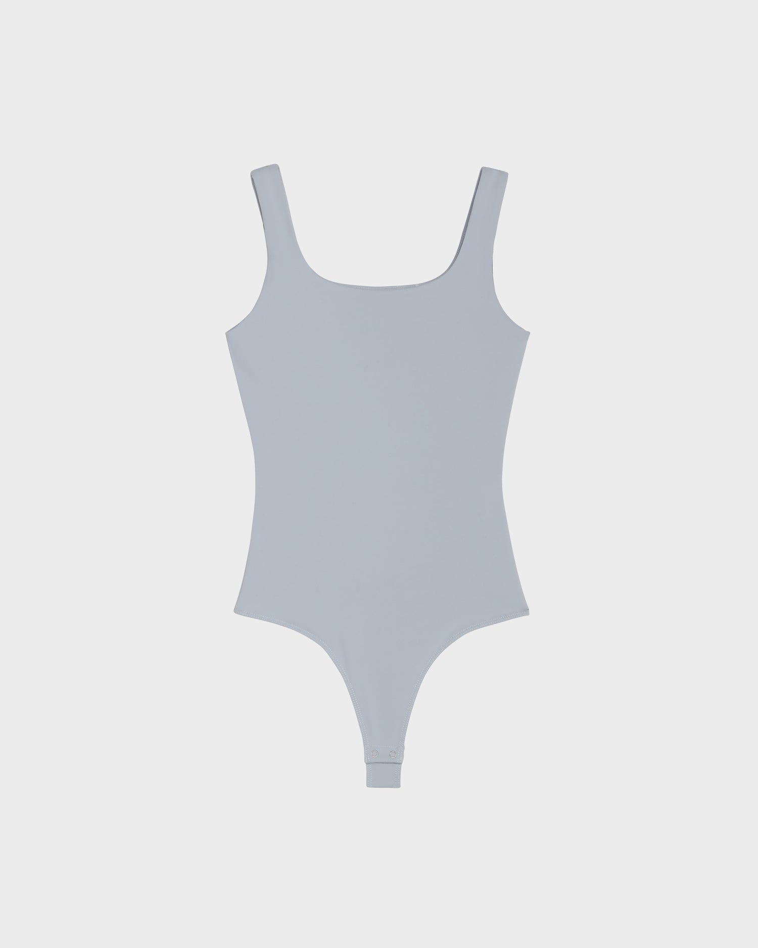 The Rudsak BRIDGET - 8524033 in Sky Blue is a women’s tank bodysuit featuring a scoop neckline, high-cut legs, and stretch fabric. The piece is shown laid flat on a plain white background.