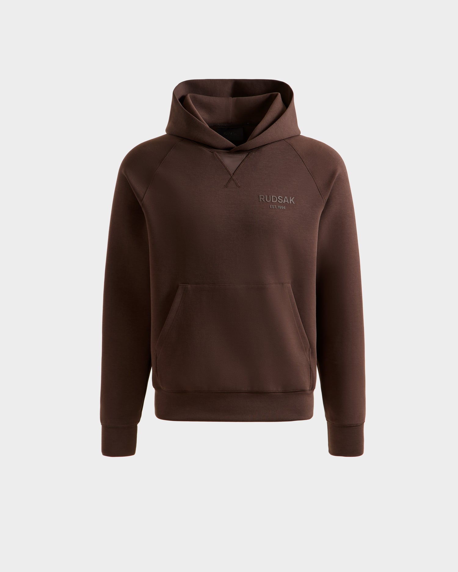 The BARRY - 9524011 Espresso W by Rudsak is a brown oversized unisex hoodie with long sleeves, a front kangaroo pocket, and a subtle chest logo, shown on a plain white background.