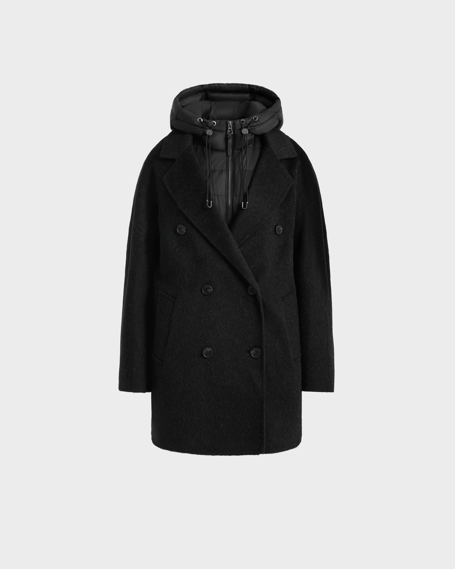 The Rudsak BETHANY - 8125625 Black coat features a black wool-silk-yak 3-in-1 silhouette, double-breasted design, wide collar, side pockets, and a detachable puffer hood, shown against a plain light gray background.