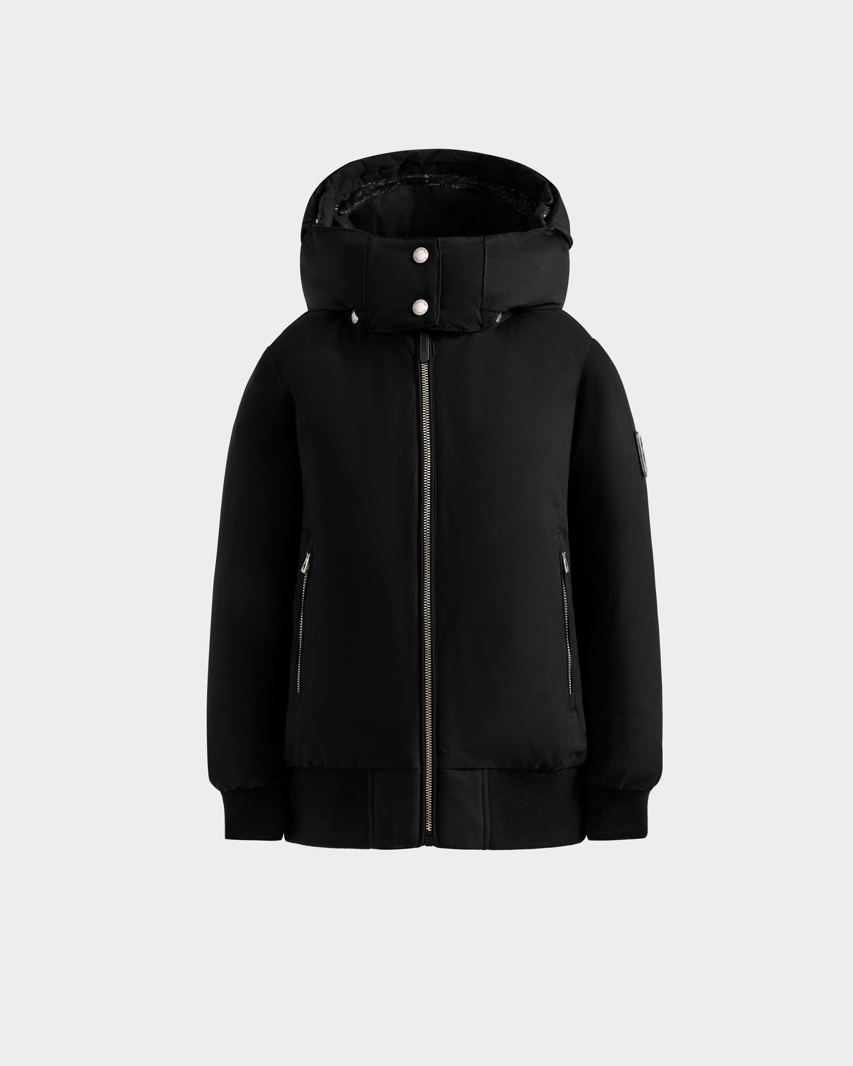 The Rudsak BOOKER K - 0124500 Black is a kids’ black weather-resistant quilted puffer jacket with a front zipper, two side zippered pockets, and snap buttons on the collar, shown on a plain light gray background.