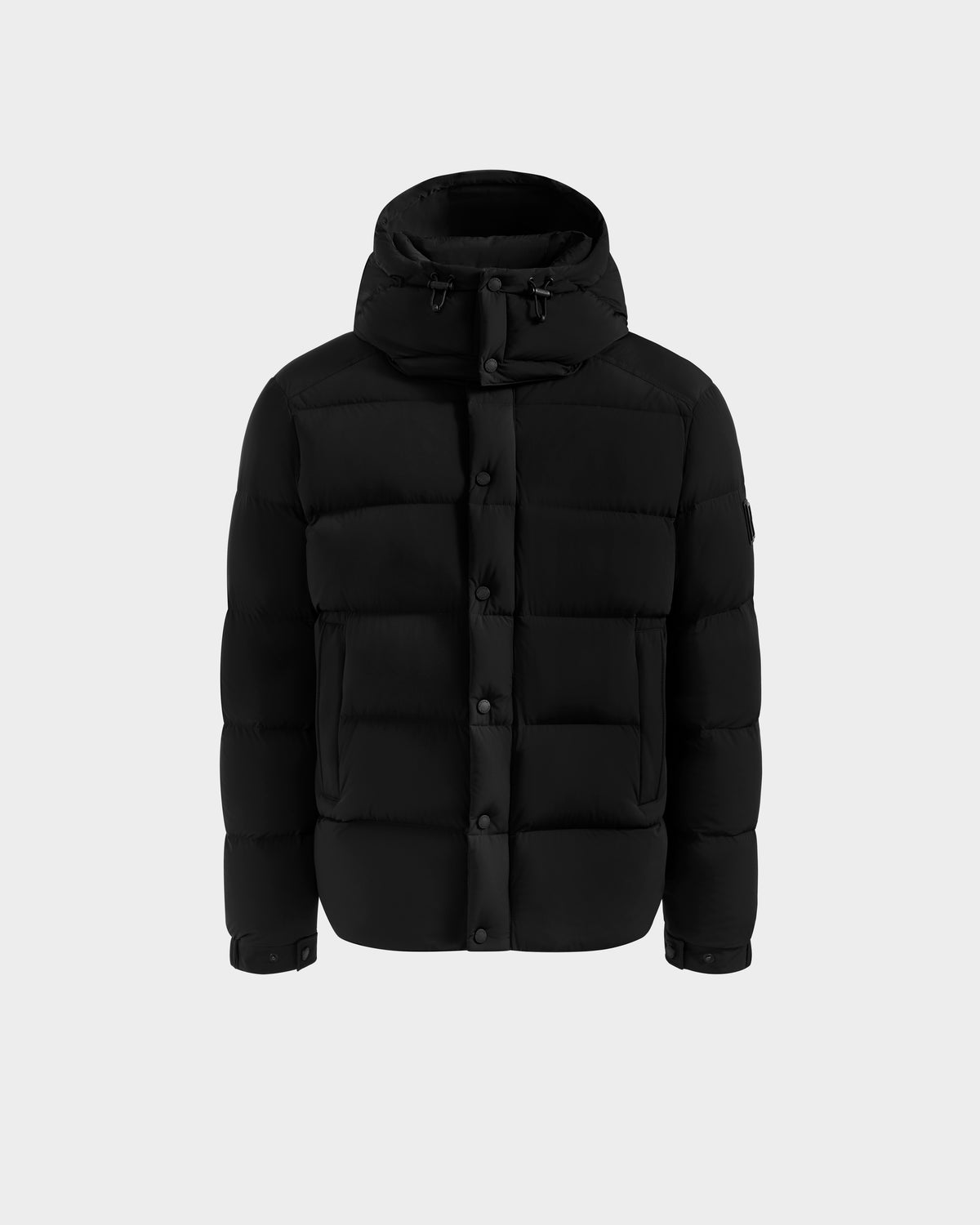 The Rudsak BRAYDEN M-S - M125524 Black is a men’s down puffer jacket with a hood, front button closure, and two large front pockets, crafted with RDS-certified down, shown on a plain light gray background.