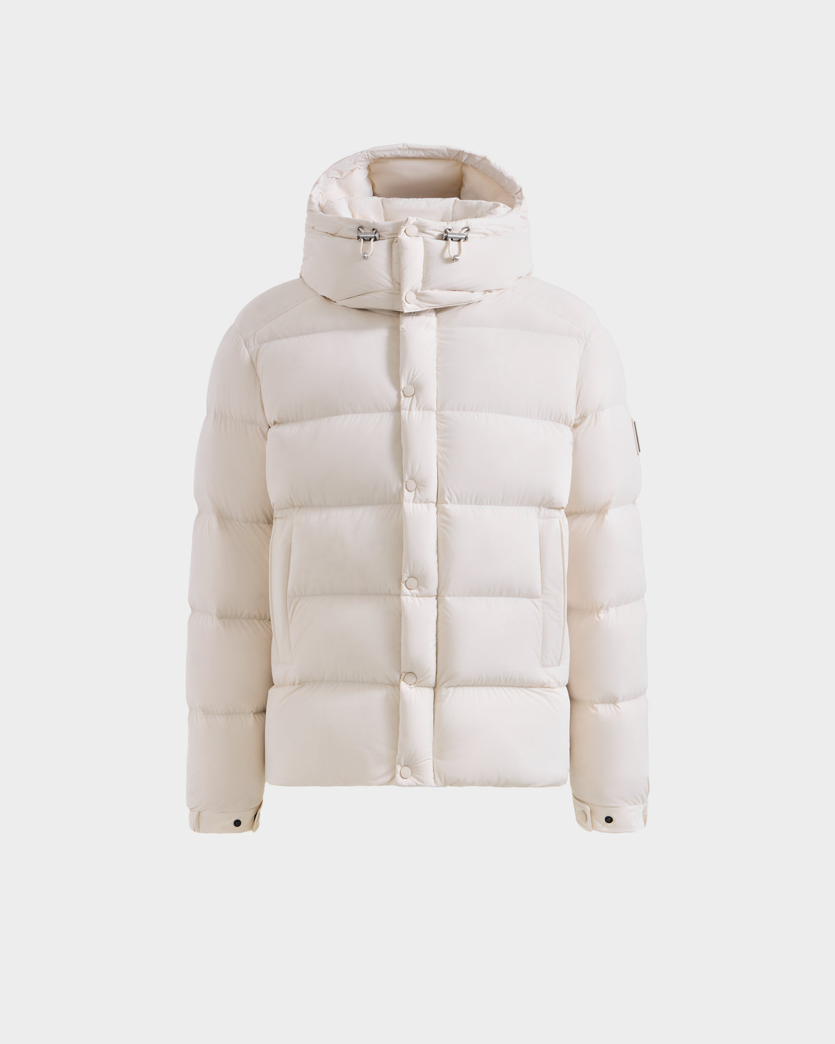 A front view of the Rudsak BRAYDEN M-S - M125524 Vanilla men’s down puffer jacket in white, featuring a hood, snap buttons, and drawstring details, displayed on a plain white background.