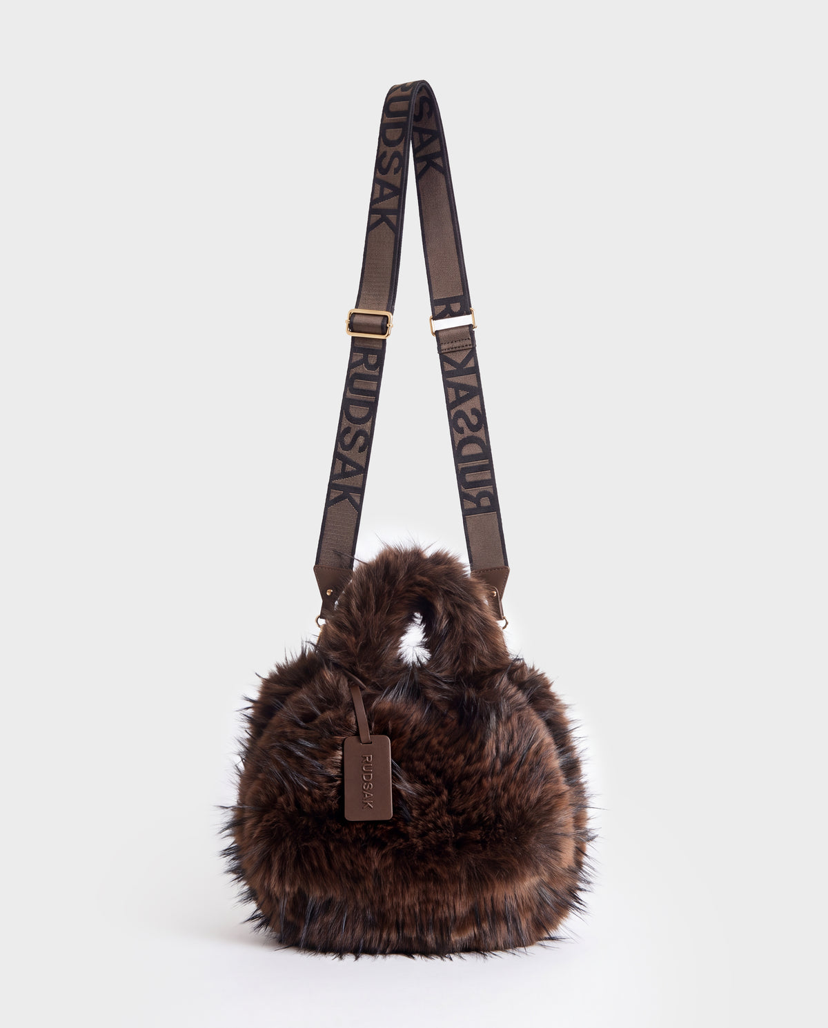 Rudsak CABAS - 8325545 Mix Expresso dark brown faux fur mini tote with two handles and an adjustable shoulder strap featuring repeating text, a perfect statement accessory for winter layers.