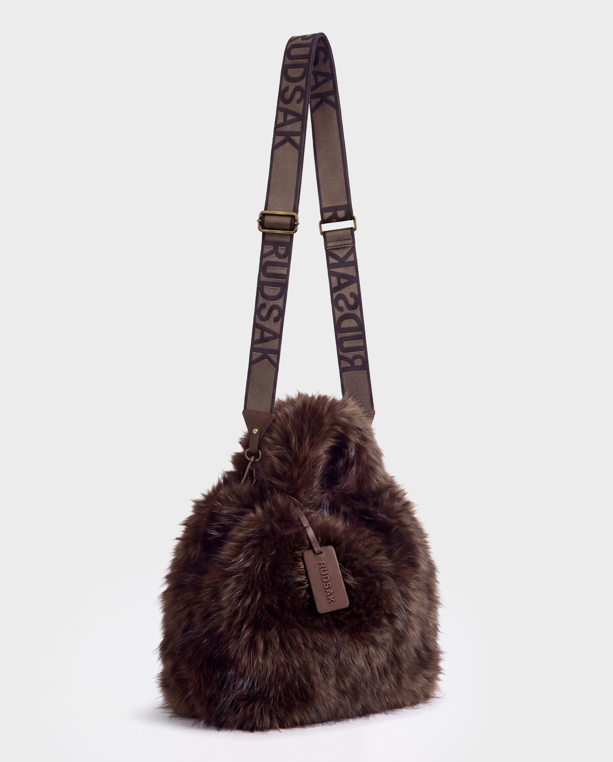 Brown faux fur CABAS - 8325545 Mix Expresso bucket bag by Rudsak with a long branded shoulder strap and matching leather luggage tag.