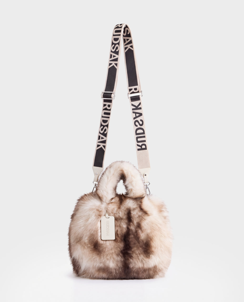 Rudsak CABAS - 8325545 Mix Vanilla fluffy faux fur mini tote featuring a branded adjustable shoulder strap and a hanging luggage tag, serving as the perfect winter statement accessory.