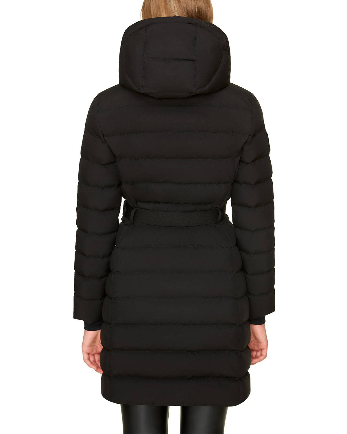 A person with straight light brown hair is shown from the back wearing the Rudsak SAMIRA - 4124503 Black women’s quilted down puffer with a belt and removable hood. The premium knee-length jacket offers exceptional insulation.