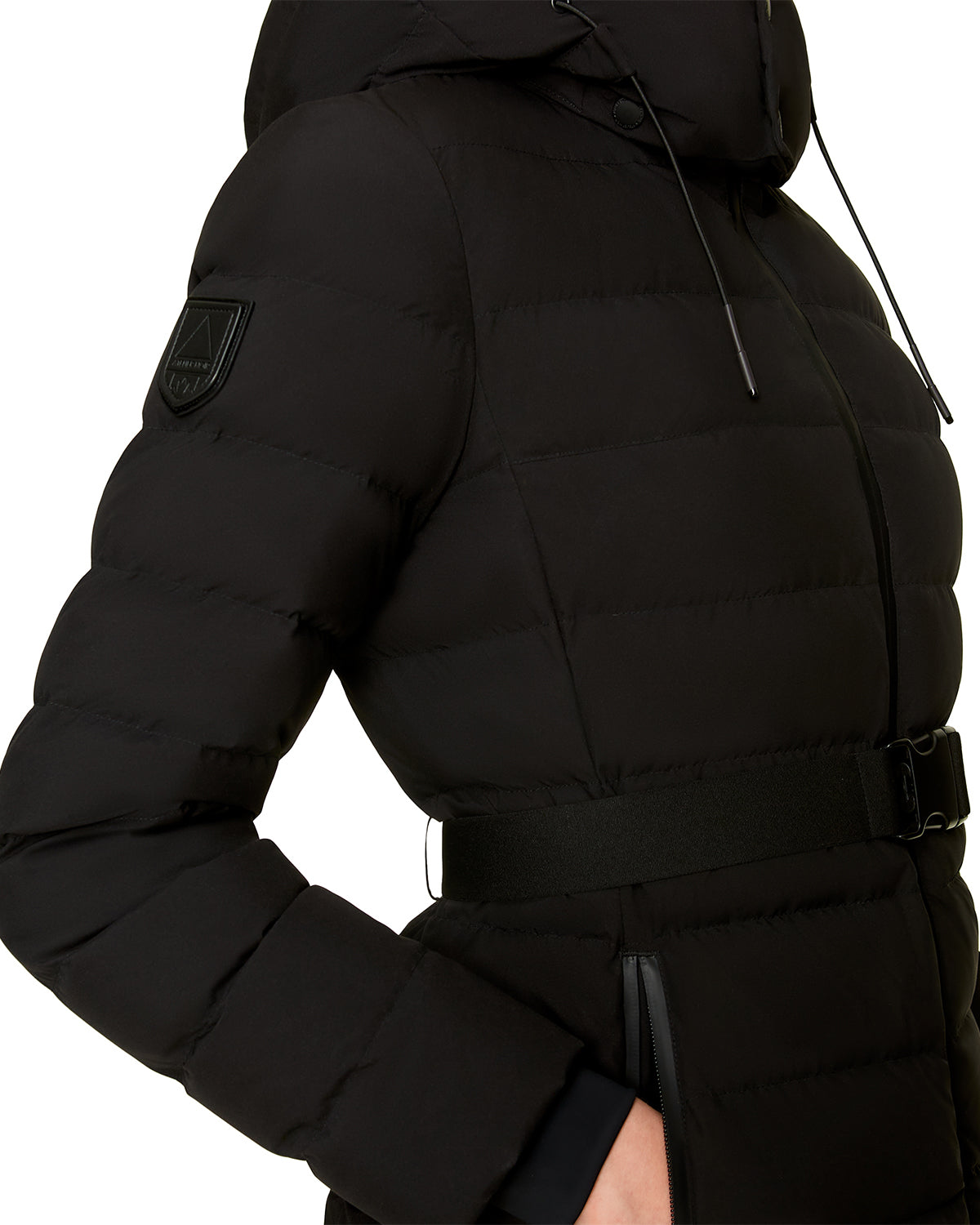 Close-up of the Rudsak SAMIRA - 4124503 Black women’s quilted down puffer, with a belted waist, zippered pockets, premium down insulation, removable hood, and fitted chic design. Only the upper body is visible.