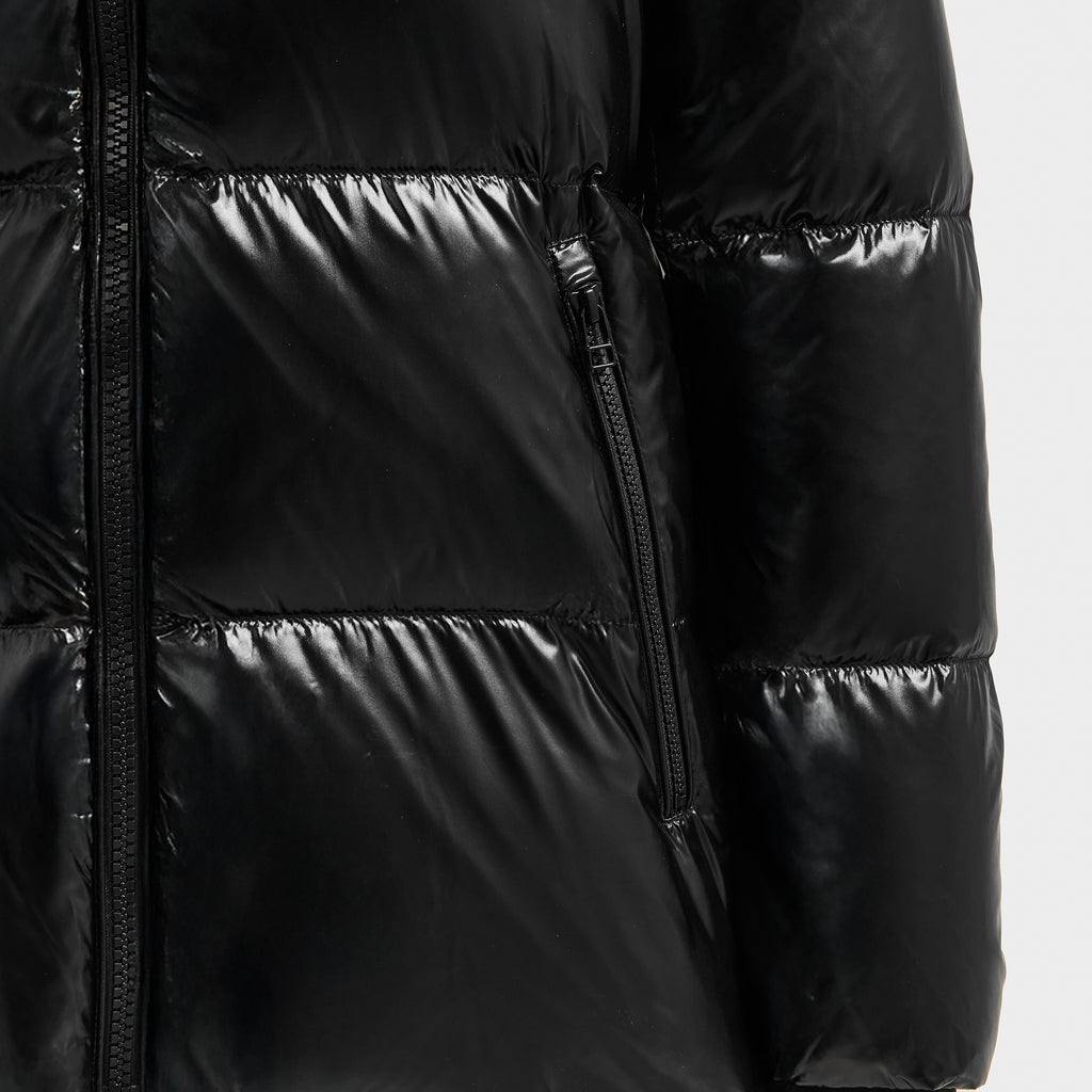 Close-up of the Rudsak MARY - 4124500 Black puffer jacket featuring shiny black duck down insulation, horizontal stitching, and a front vertical zippered pocket.