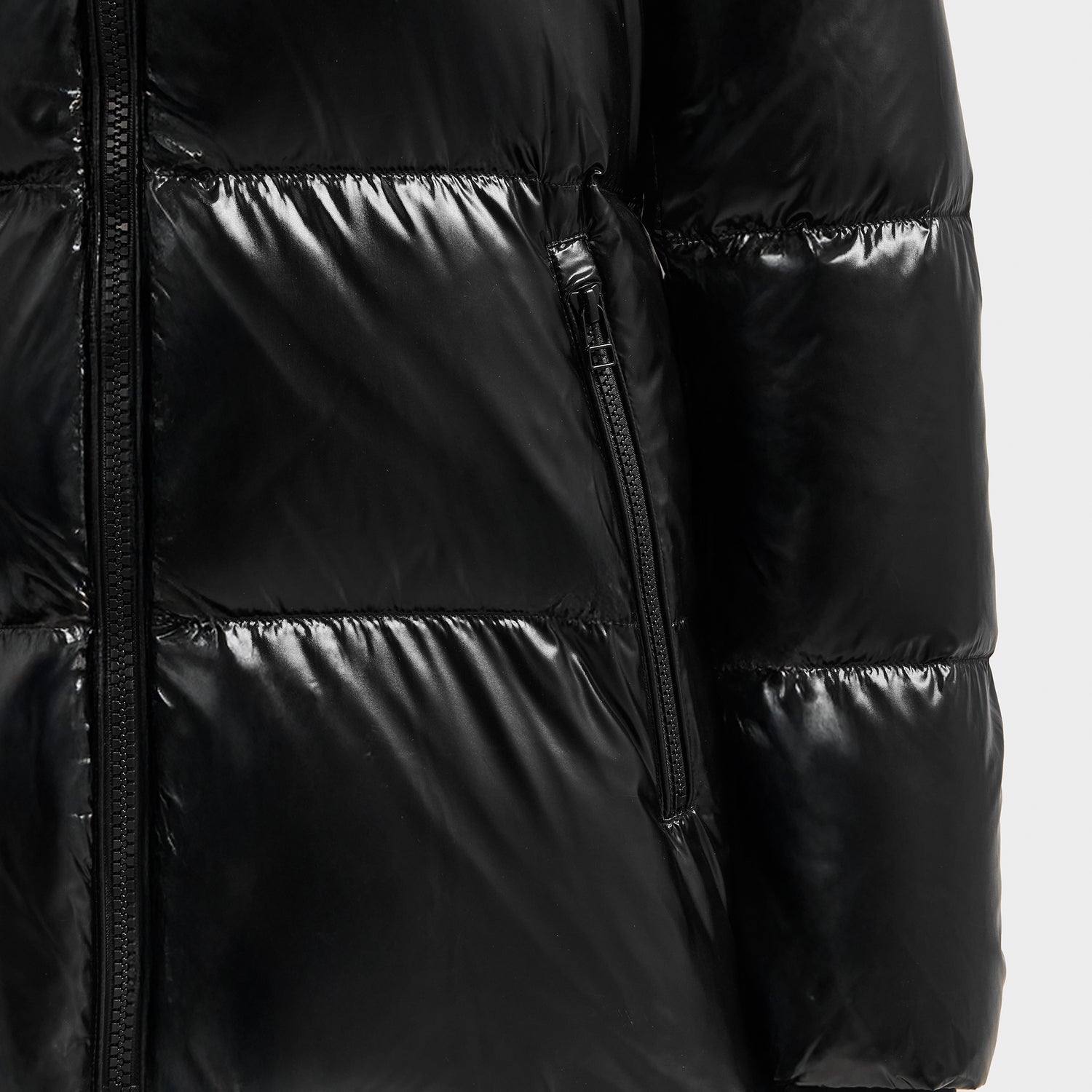 Close-up of the Rudsak MARY - 4124500 Black puffer jacket featuring shiny black duck down insulation, horizontal stitching, and a front vertical zippered pocket.