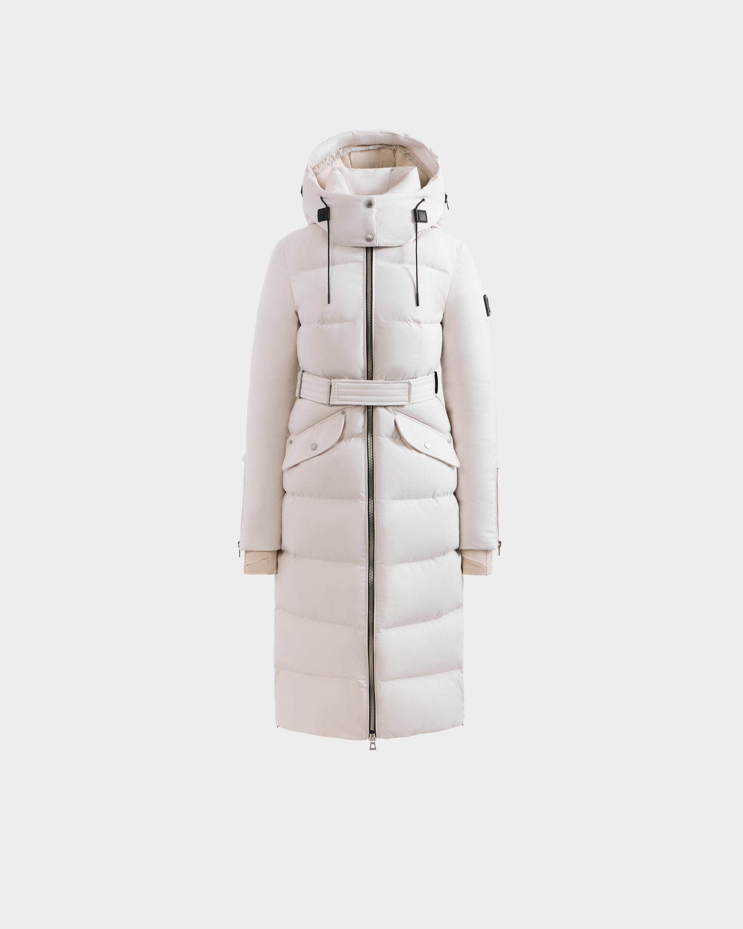 The Rudsak CALI H - 8125614 Vanilla is a long white women’s down parka with high-loft fill, front zipper, adjustable waist belt, flap pockets, and removable hood, shown on a plain white background.