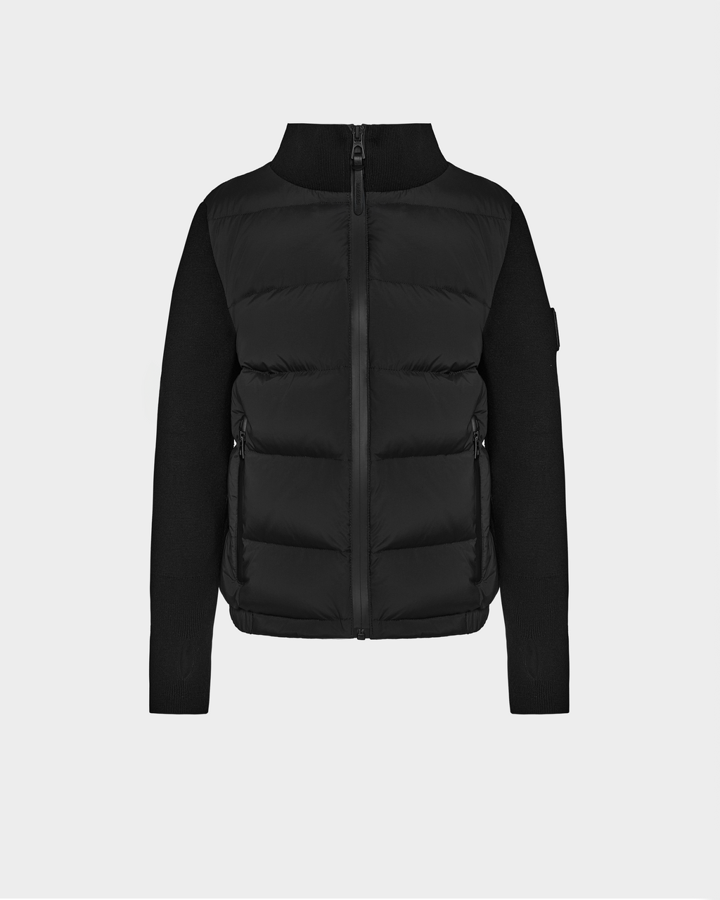 The Rudsak CAMILLE HV - H125500 Black is a limited-edition puffer jacket featuring a high collar, front zipper, zippered side pockets, and fitted sleeves and sides contrasting with the quilted front and back.