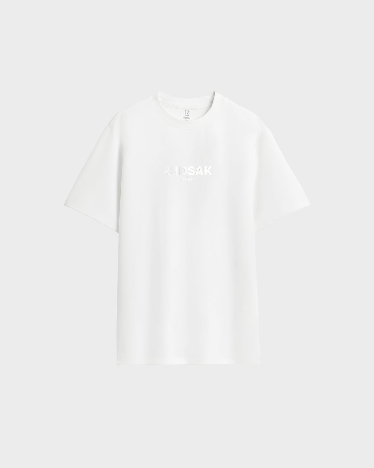 The Rudsak CASEY - 6525037 Optic White mens T-shirt is a comfortable essential featuring the word RUDSAK subtly printed in white on the chest, set against an optic white background.