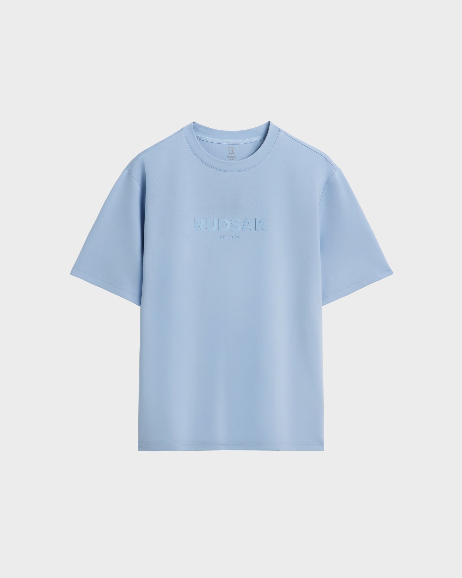 The CASEY - 6525037 Sky Blue men's T-shirt by Rudsak features EST. 1994 embossed on the front. This comfortable essential is shown against a plain white background.