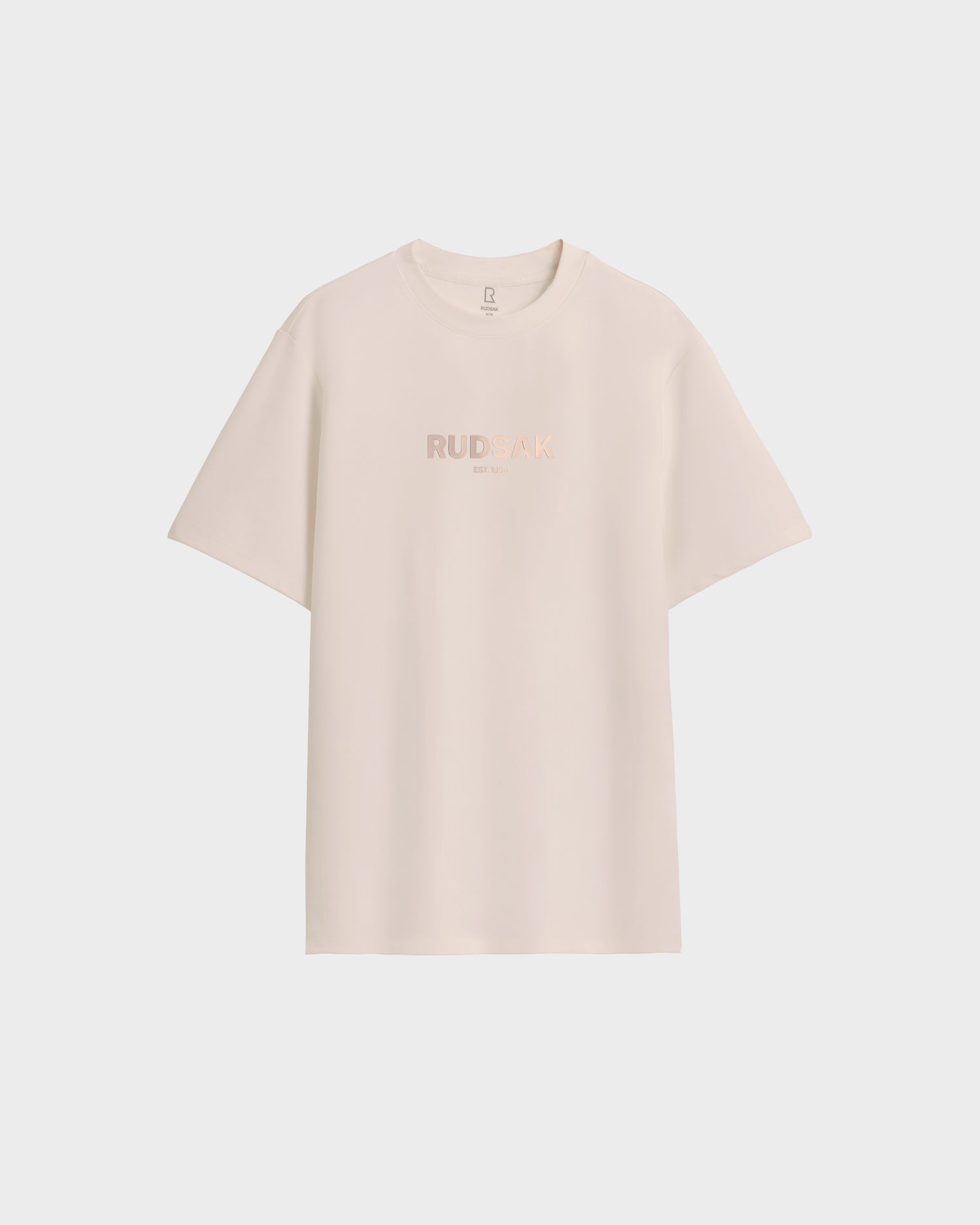 The CASEY - 6525037 Vanilla men’s T-shirt by Rudsak in light beige features subtle chest lettering. Shown on a white background, it’s an understated wardrobe staple.