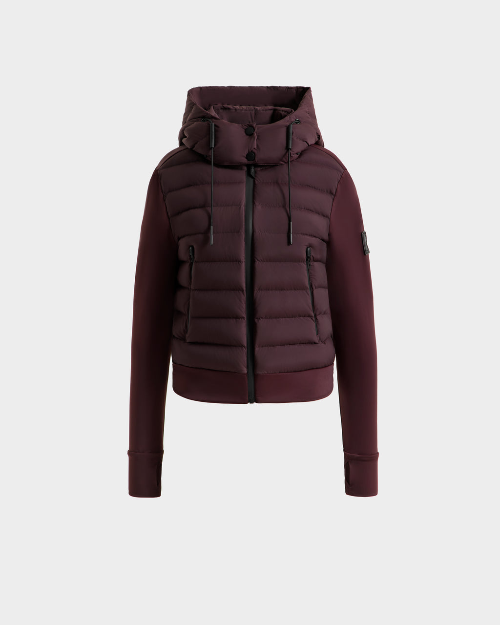 The Rudsak CASSA - 8125057 Bordeaux is a maroon women's transitional jacket with a hood, front zipper, and black drawstrings. Featuring horizontal quilting and ribbed cuffs, this lightweight cropped jacket is shown against a white background.