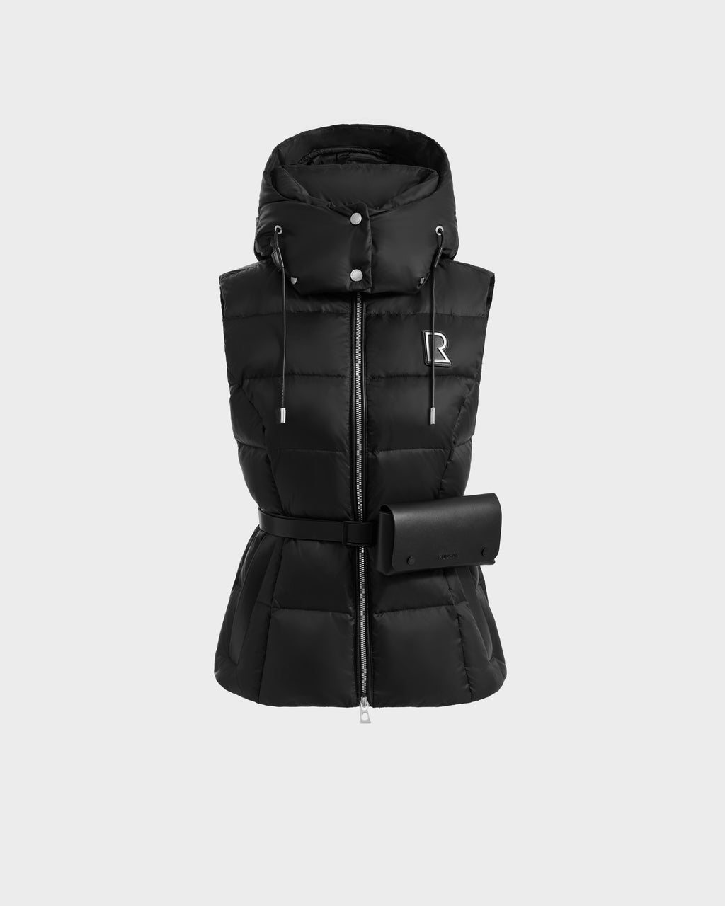 The CASSIDY N - 8125677 Black by Rudsak is a travel-friendly, sleeveless puffer vest for women featuring lightweight warmth, a high collar, drawstrings, front zipper, belted waist, small pouch, quilted design, and signature silver R logo.