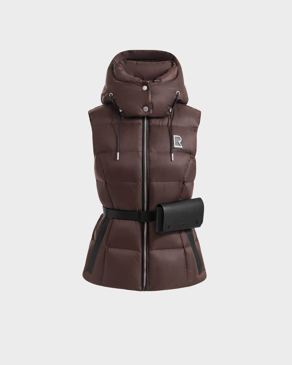 The Rudsak CASSIDY N - 8125677 Espresso is a brown women’s fitted down vest with lightweight warmth, recycled nylon shell, hood with drawstrings, front zipper, belted waist with black pouch, and an embroidered R logo on the chest.