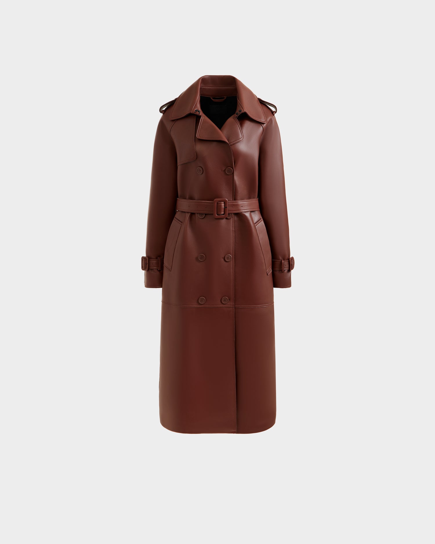 The Rudsak CASSIE L-B - 8125553 Rust is a women’s double-breasted rust trench coat featuring a matching belt, wide lapels, and buttoned sleeve straps, shown on a plain white background.
