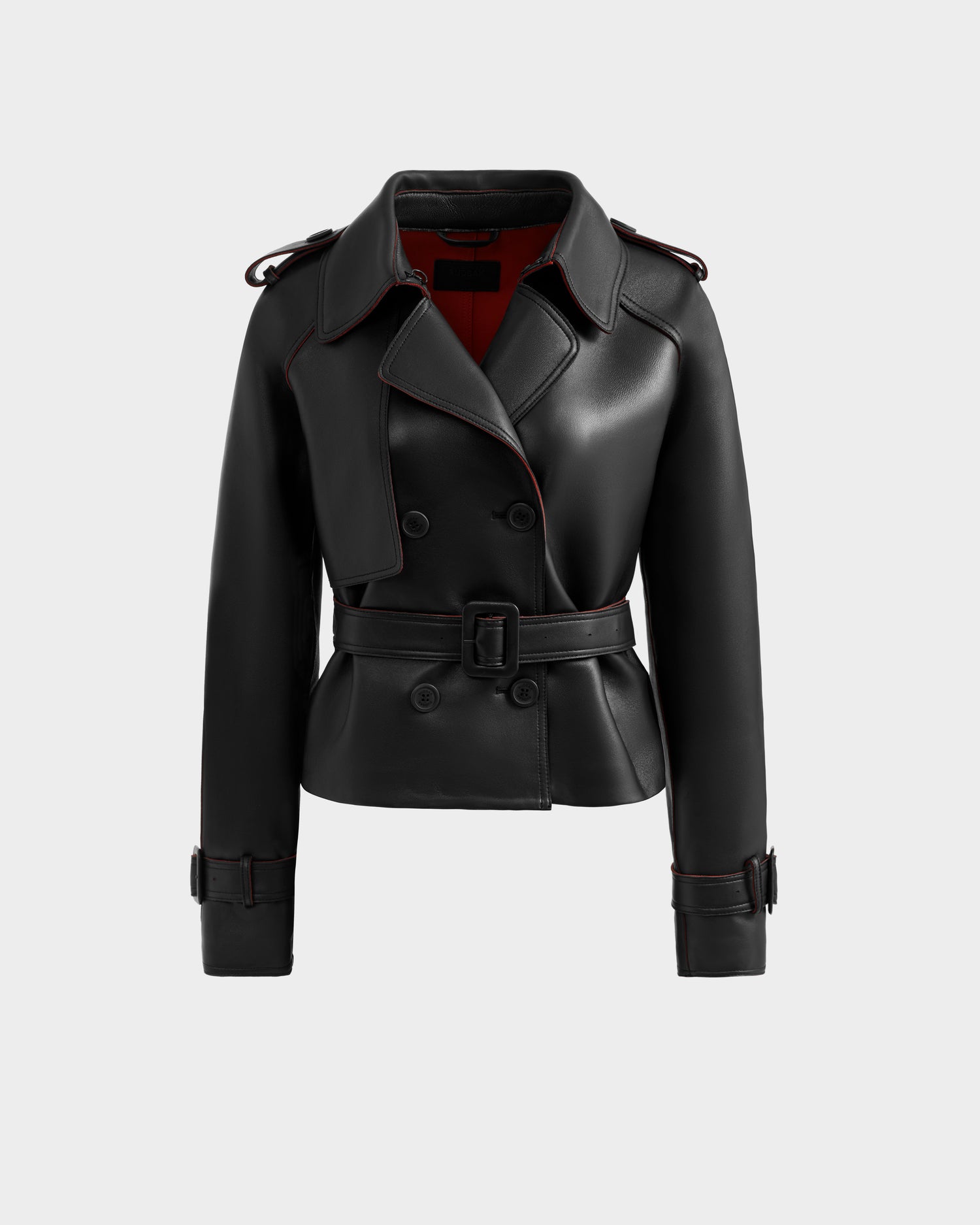 The CASSIE S-B - 8125554 Black by Rudsak is a black bonded leather double-breasted jacket with a waist belt, shoulder epaulets, buckled cuffs, and red lining, shown against a plain light gray background.