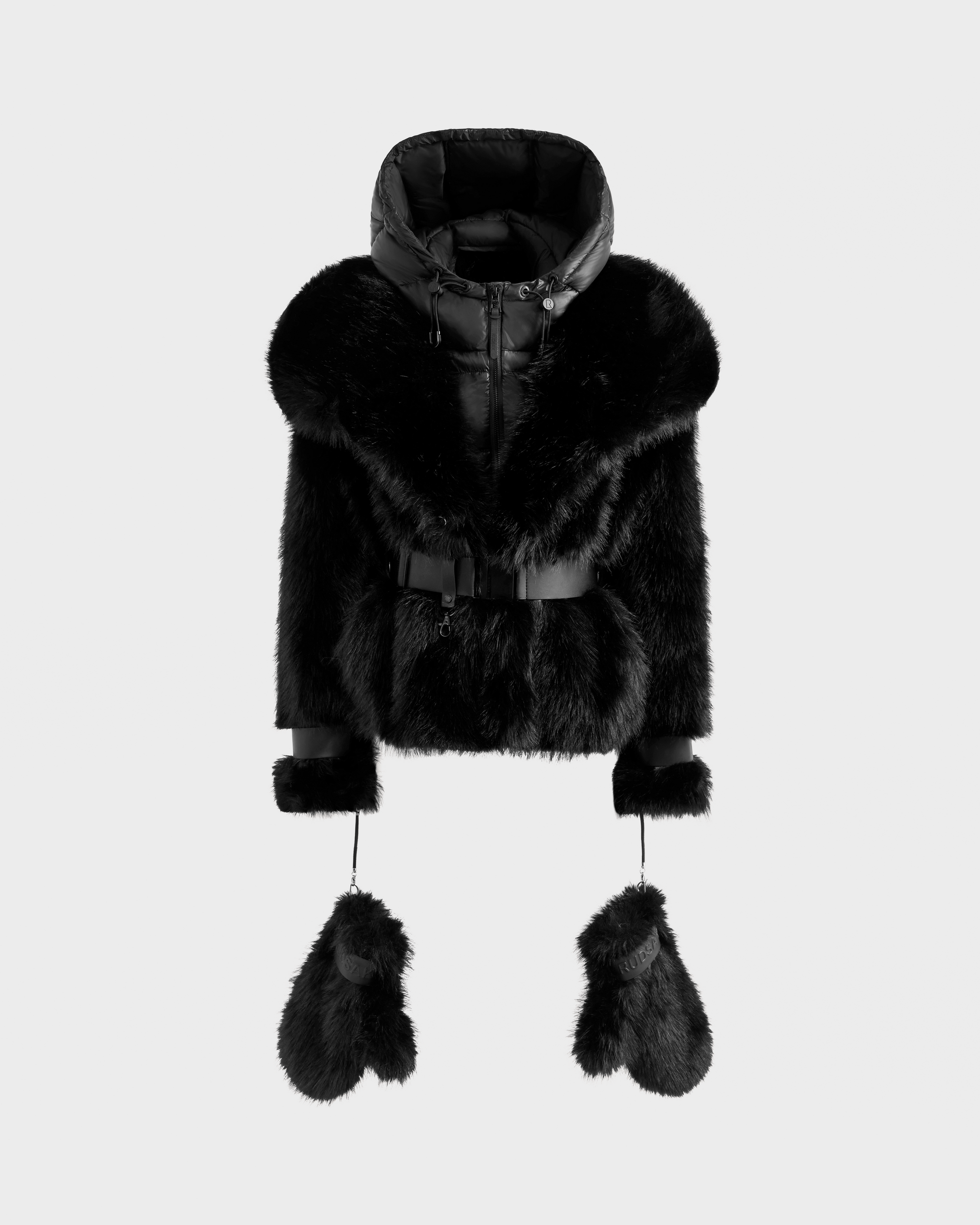 The CHLOE - 8125619 Black by Rudsak is a women's black faux fur jacket with a hood, belted waist, and matching fur mittens attached by cords—an elegant winter staple, shown on a plain light background.