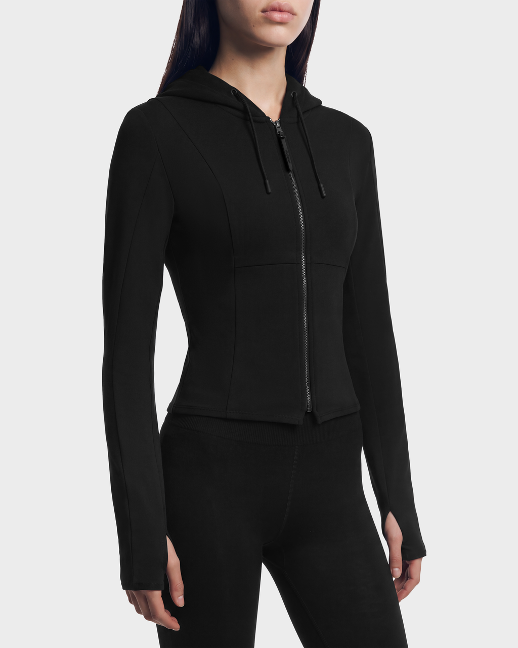 Rudsak JUNIPER - 8526679 Black/Black fitted zip-up hoodie in a stretch cotton blend, featuring a cropped silhouette, drawstring hood, and thumbhole cuffs.