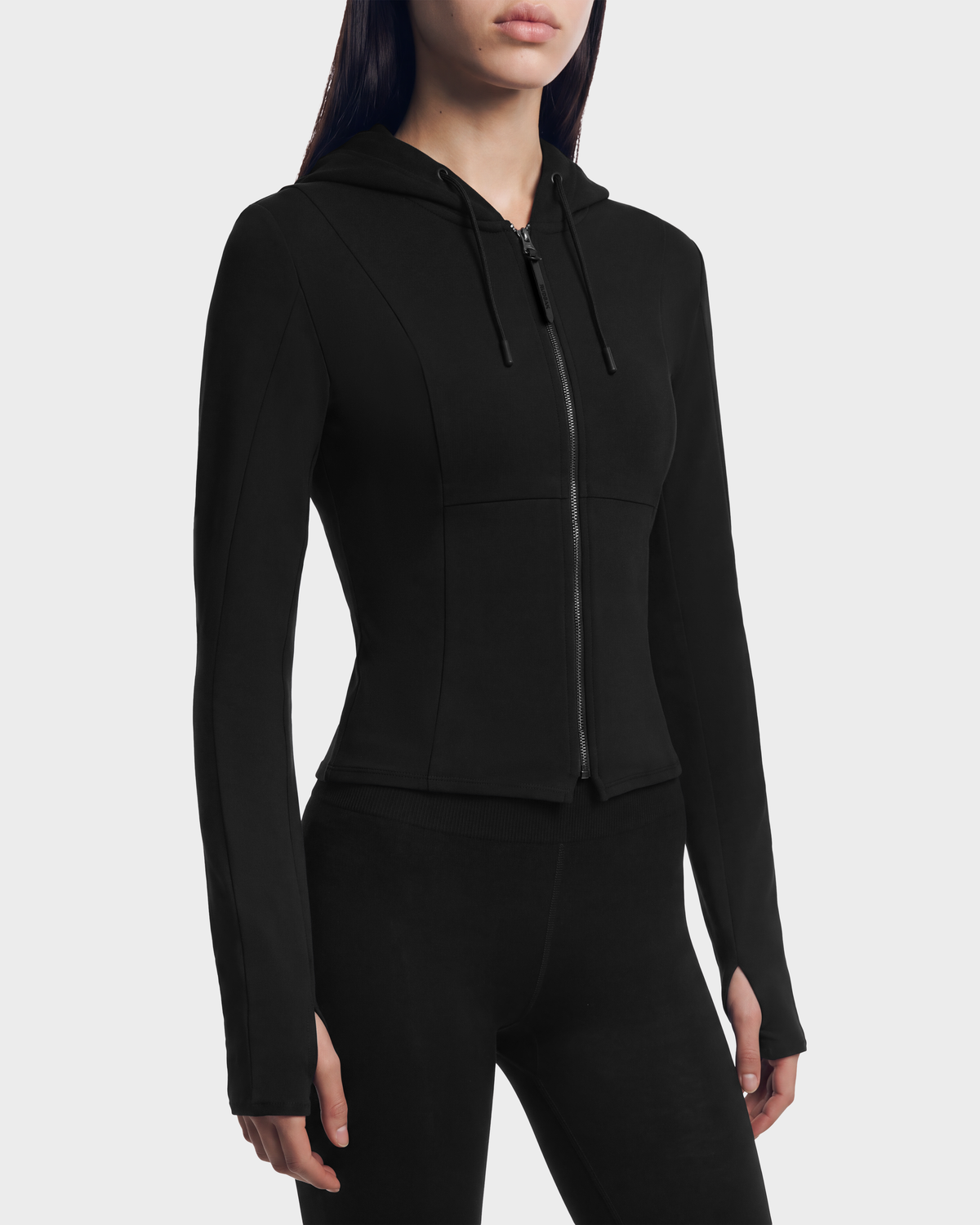 Rudsak JUNIPER - 8526679 Black/Black fitted zip-up hoodie in a stretch cotton blend, featuring a cropped silhouette, drawstring hood, and thumbhole cuffs.