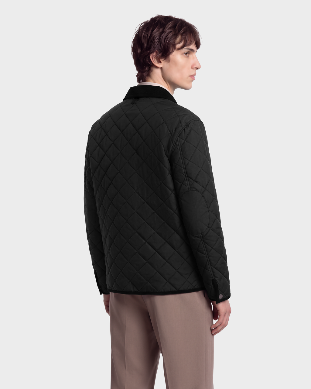 A man seen from the back wearing a black Rudsak MONTY - 6126722 Black quilted jacket with a dark collar.