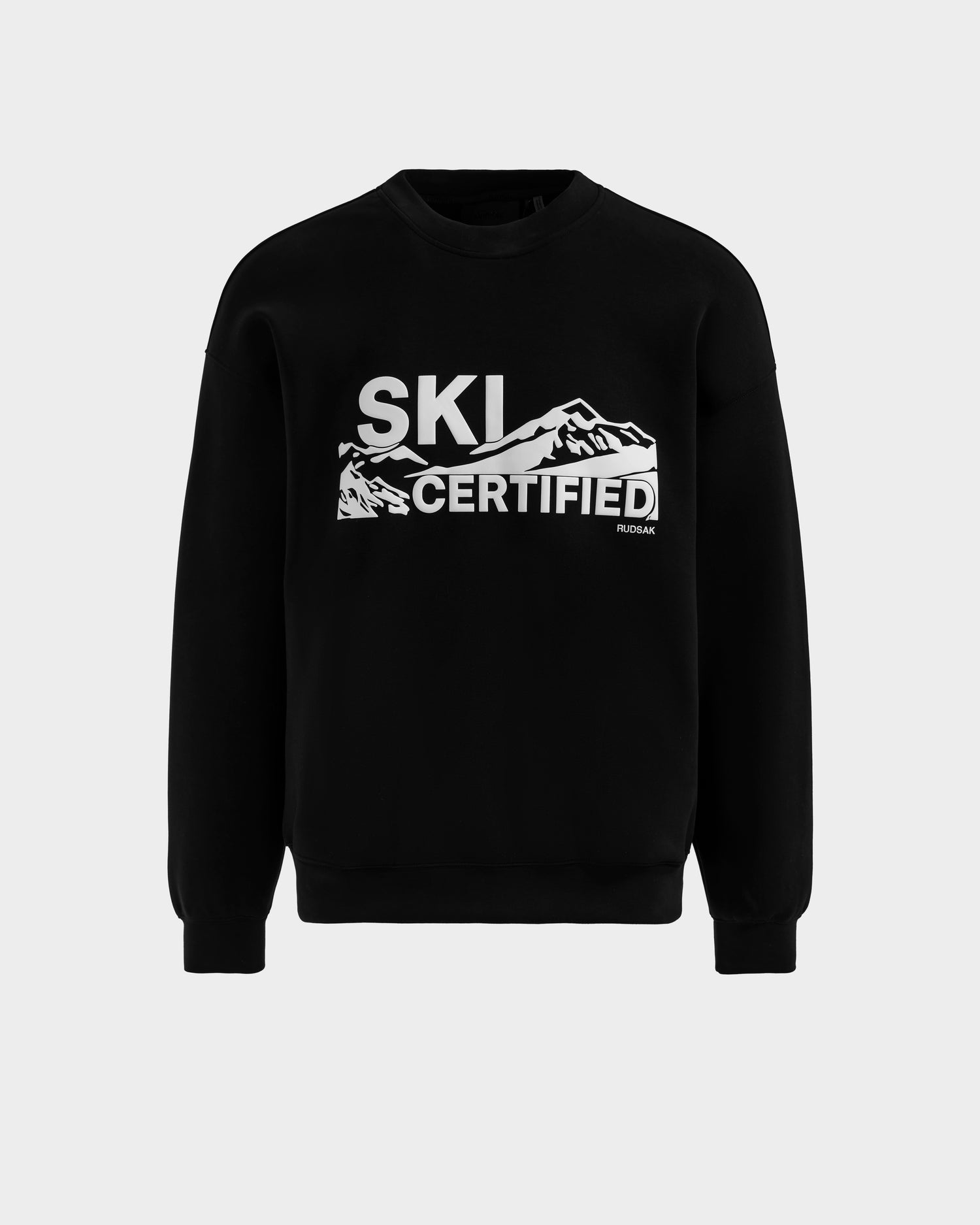 The Rudsak DECLAN - 6525648 Black is a men’s crewneck sweater with "SKI CERTIFIED" in white and snow-capped mountain graphics—perfect for winter adventures.