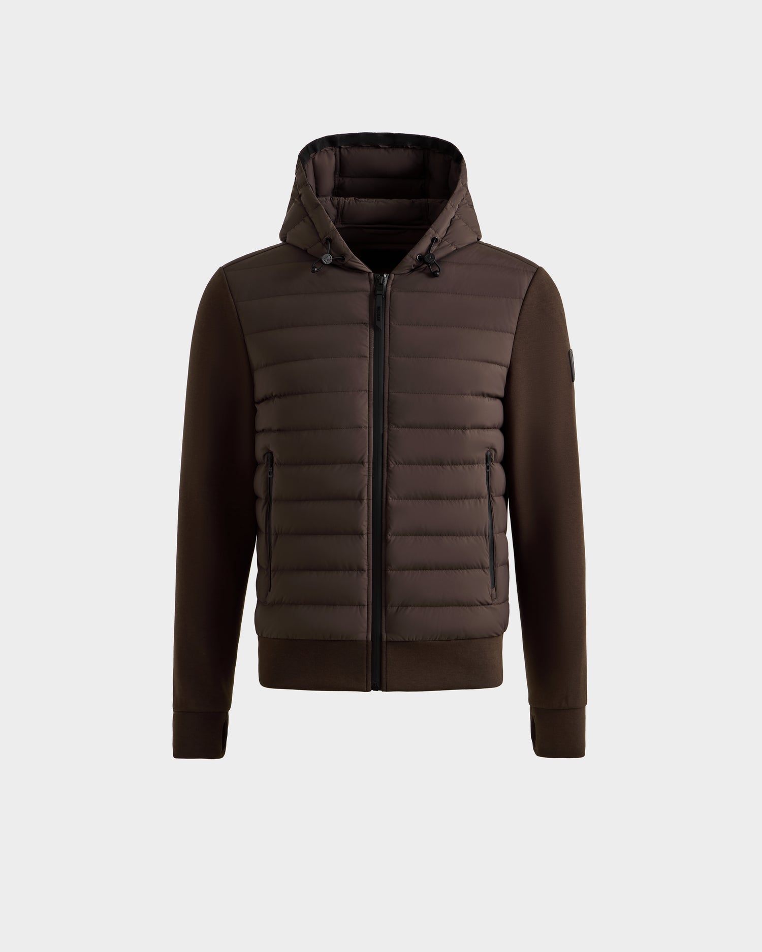 The DEE MAT - 6124028 Espresso by Rudsak is a men's lightweight hybrid down jacket featuring a quilted front, zip closure, and side pockets. Smooth sleeves and sides contrast with the puffy front for a modern urban look on a light gray background.