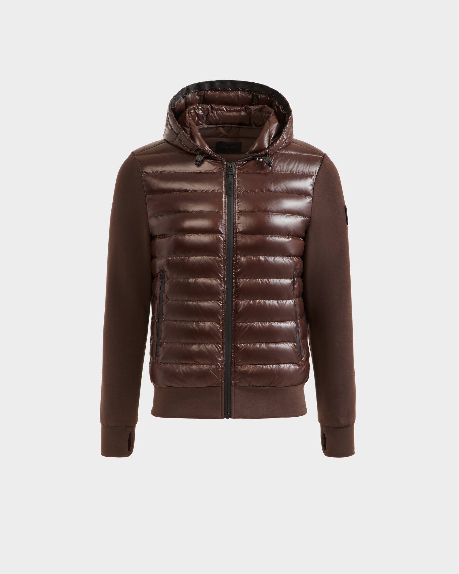 The Rudsak DEE S - 6125684 Espresso is a men’s brown lightweight down jacket with a shiny quilted front and matte sleeves, filled with RDS-certified duck down. It features a front zipper and side pockets, shown on a plain white background.