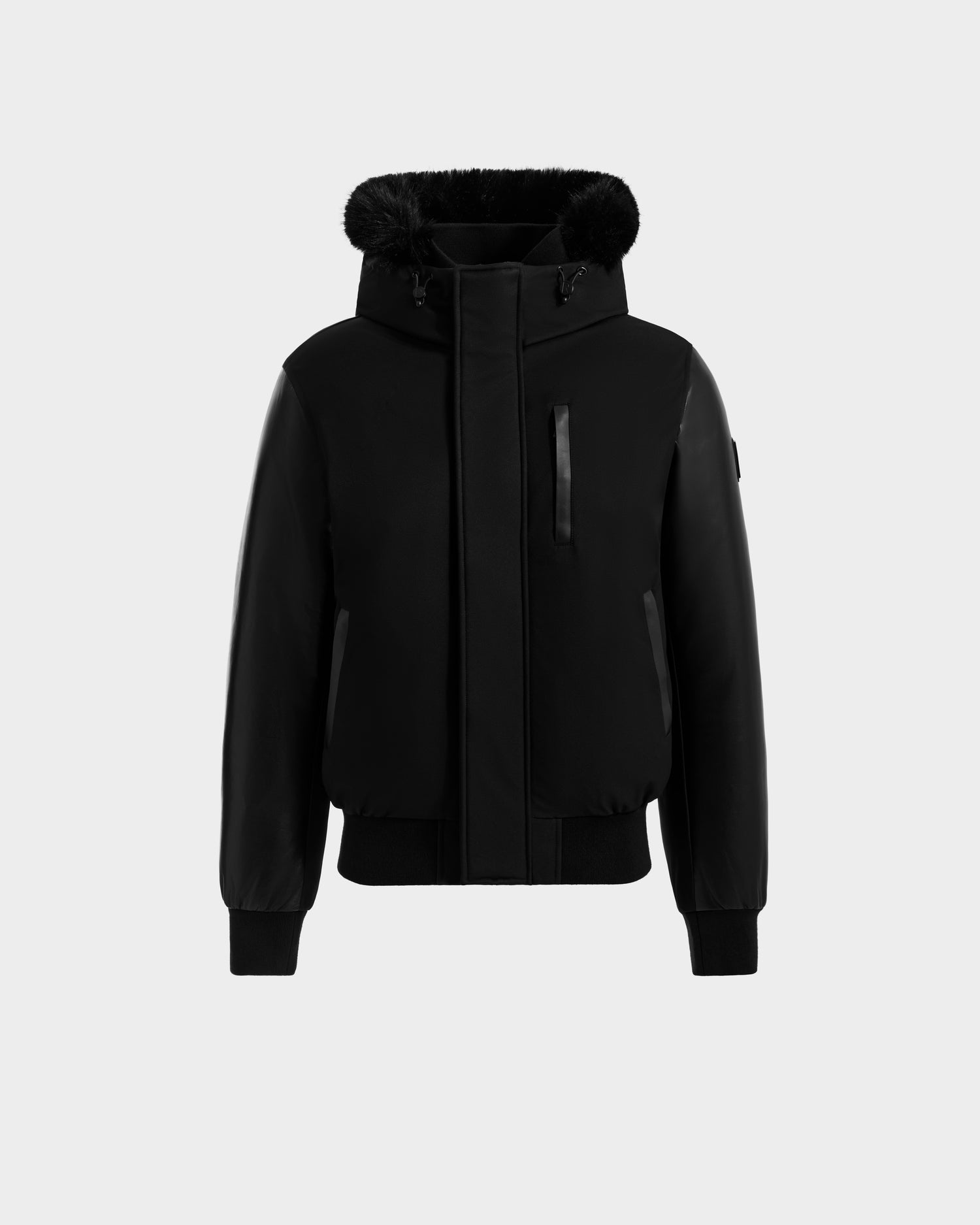 The Rudsak DERON - M125539 Black men’s down bomber jacket features a front zipper, ribbed cuffs and hem, vegan-leather sleeves, two side pockets, one chest pocket, and a fur-trimmed hood, shown on a plain light gray background.