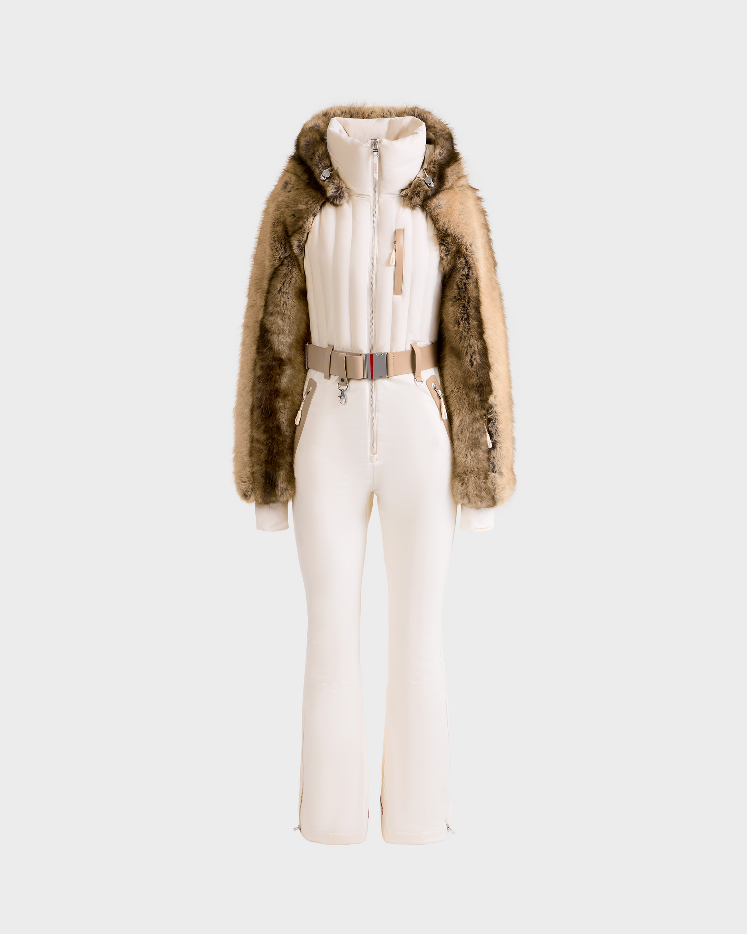 The Rudsak DESTINY - 8124727 Vanilla is a stylish, fitted one-piece ski suit featuring a fur-trimmed hood, brown fur sleeves, belted waist, and zippered front, displayed against a plain light background.