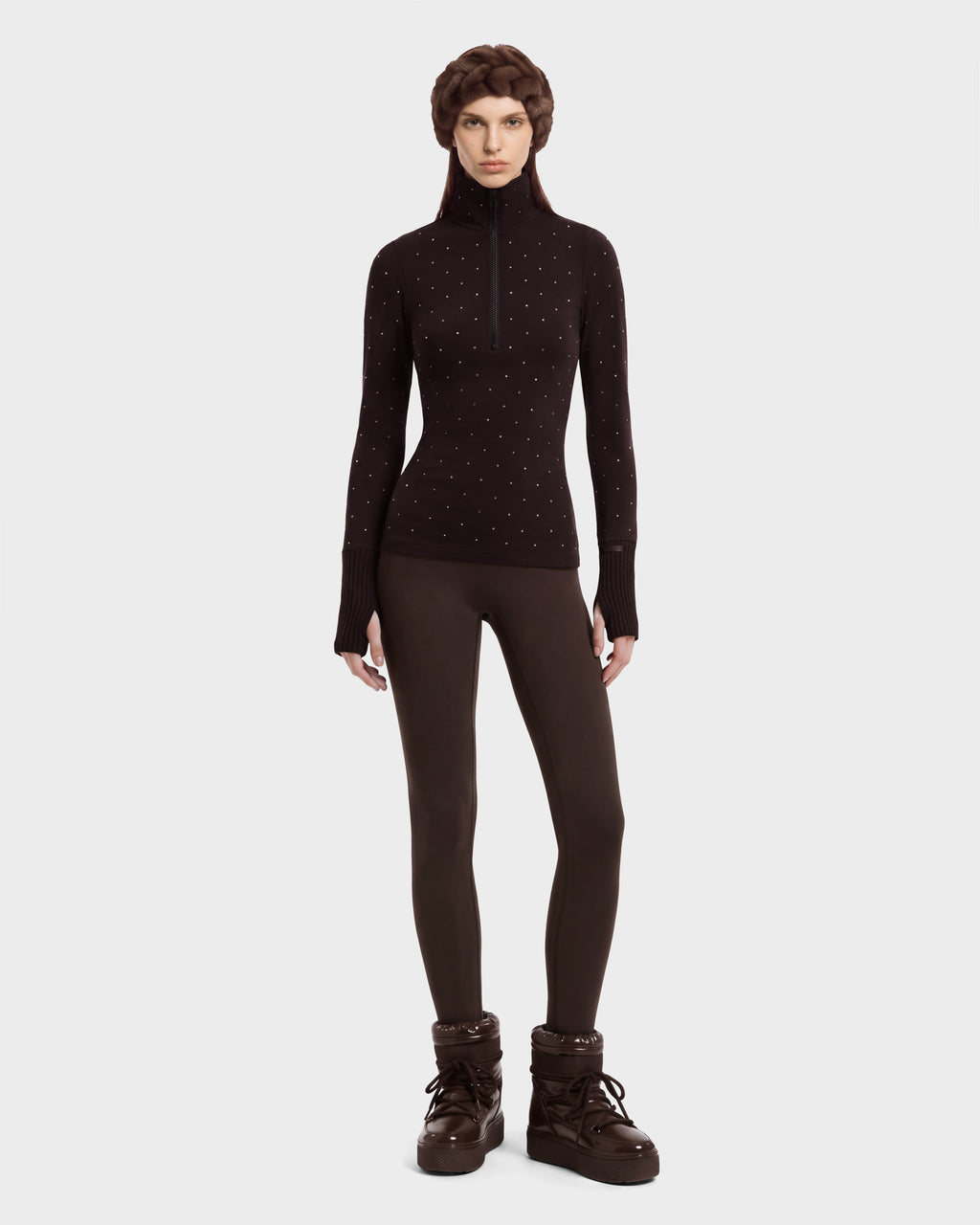 A model wears the NEVA - 8526524 Espresso brown thermal long-sleeve zip-up sweater with small embellishments, paired with matching brown leggings, winter boots, and a hat.