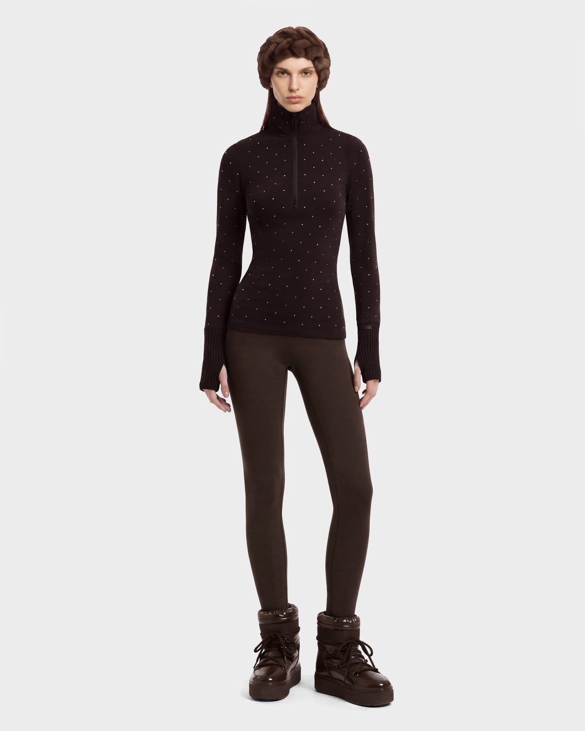 A model wears the NEVA - 8526524 Espresso brown thermal long-sleeve zip-up sweater with small embellishments, paired with matching brown leggings, winter boots, and a hat.