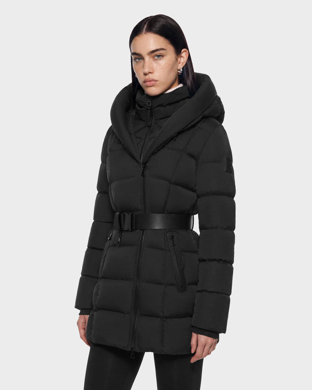 A black Rudsak TAYLOR M - 8125965 puffer jacket with a large hood and a wide belt at the waist.