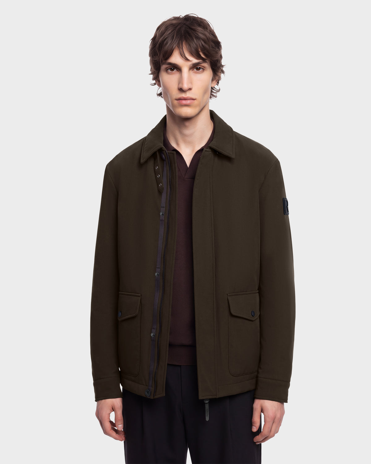 Man wearing an ANTOINE - 6126506 Olive dark olive green collared jacket over a dark brown polo shirt.