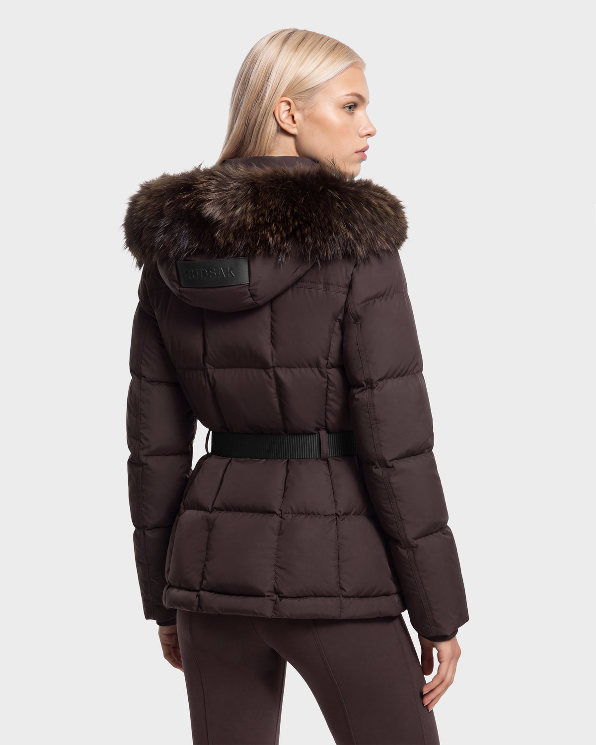 A dark brown Rudsak GRACE FF - 8126535 Espresso puffer jacket with a fur-trimmed hood and a black belted waist, seen from behind.