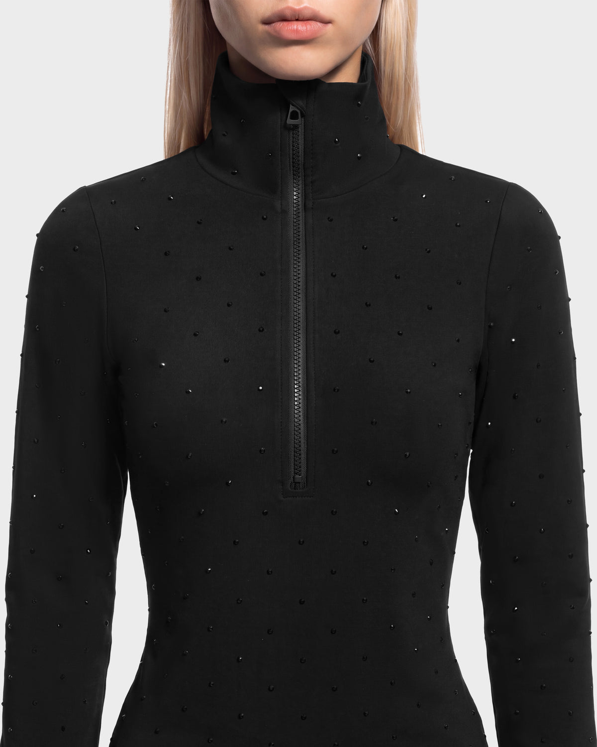 NEVA - 8526524 Black long-sleeved top featuring a high collar, front zipper, and scattered black studs.