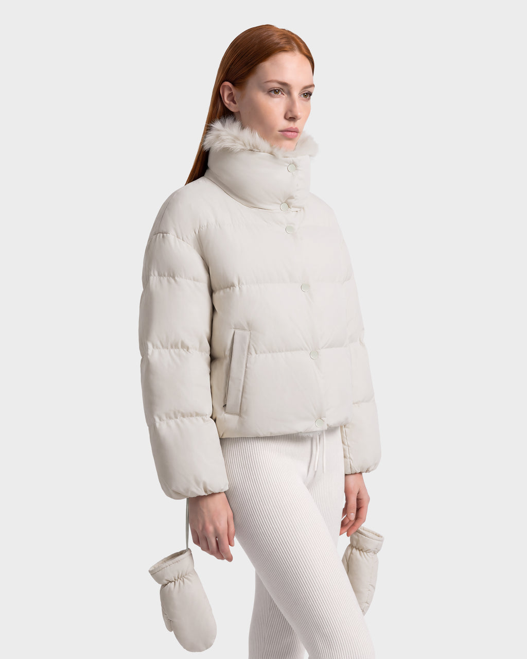 Rudsak ALONDRA - 8126992 Vanilla cropped cream-colored puffer jacket with a high collar and faux-fur trim, paired with matching leggings and mittens as part of a winter outerwear set.