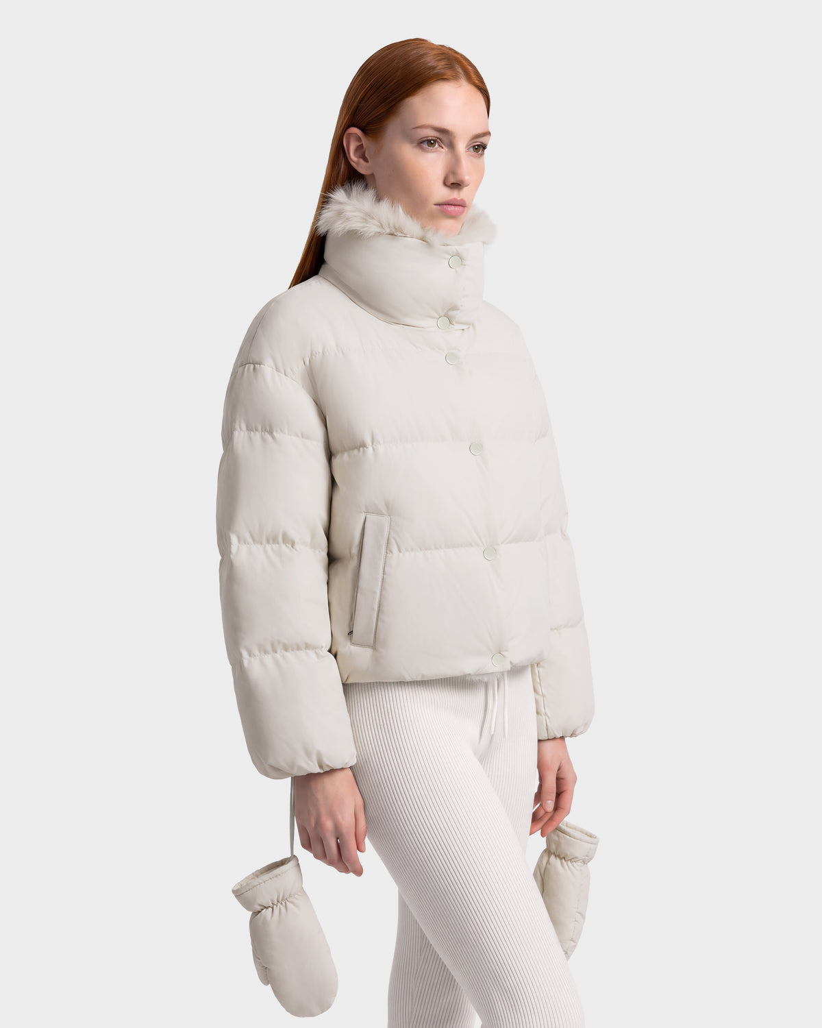Rudsak ALONDRA - 8126992 Vanilla cropped cream-colored puffer jacket with a high collar and faux-fur trim, paired with matching leggings and mittens as part of a winter outerwear set.