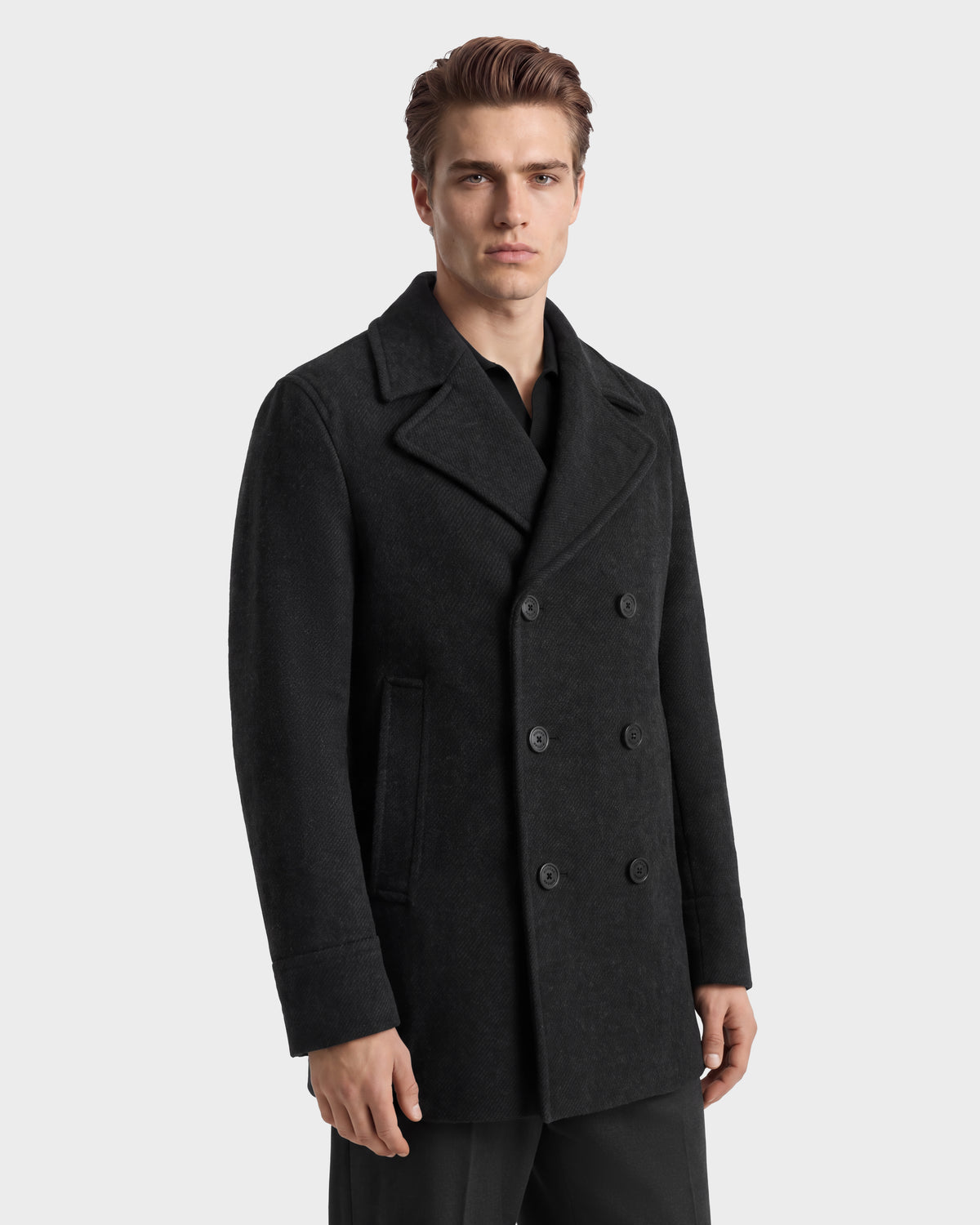 A man wearing a charcoal LUCIEN - 6126508 wool-blend double-breasted pea coat over a black shirt.